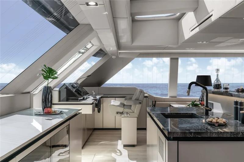 Luxurious interior of 2026 Sunreef 80 Sunreef Power yacht with modern kitchen and ocean view.