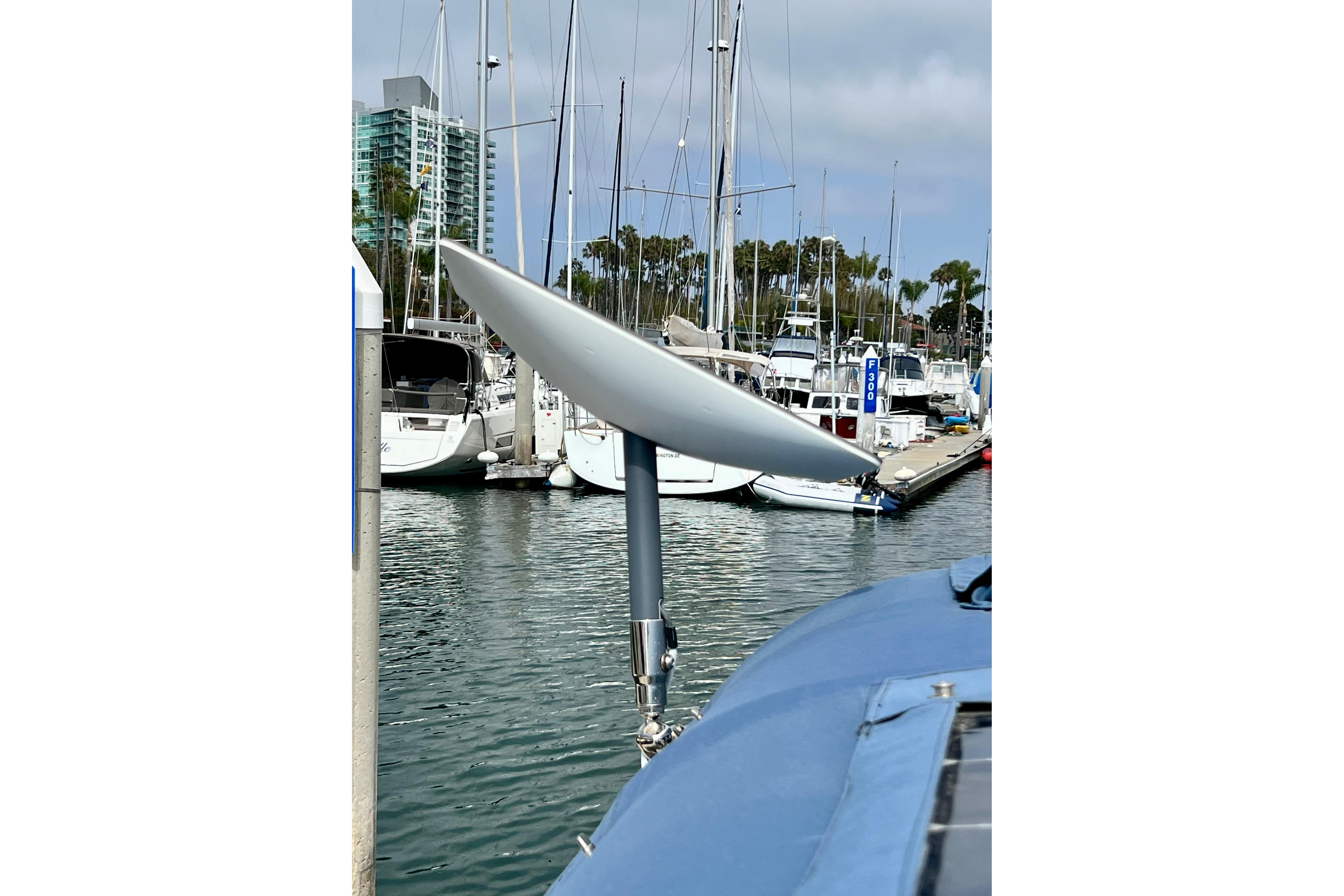 Sailboat Hanse 455 (2016) with satellite dish in marina, surrounded by other boats.