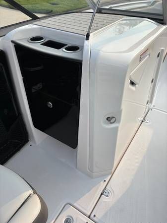 Interior of a 2021 Yamaha AR250 boat with storage area.
