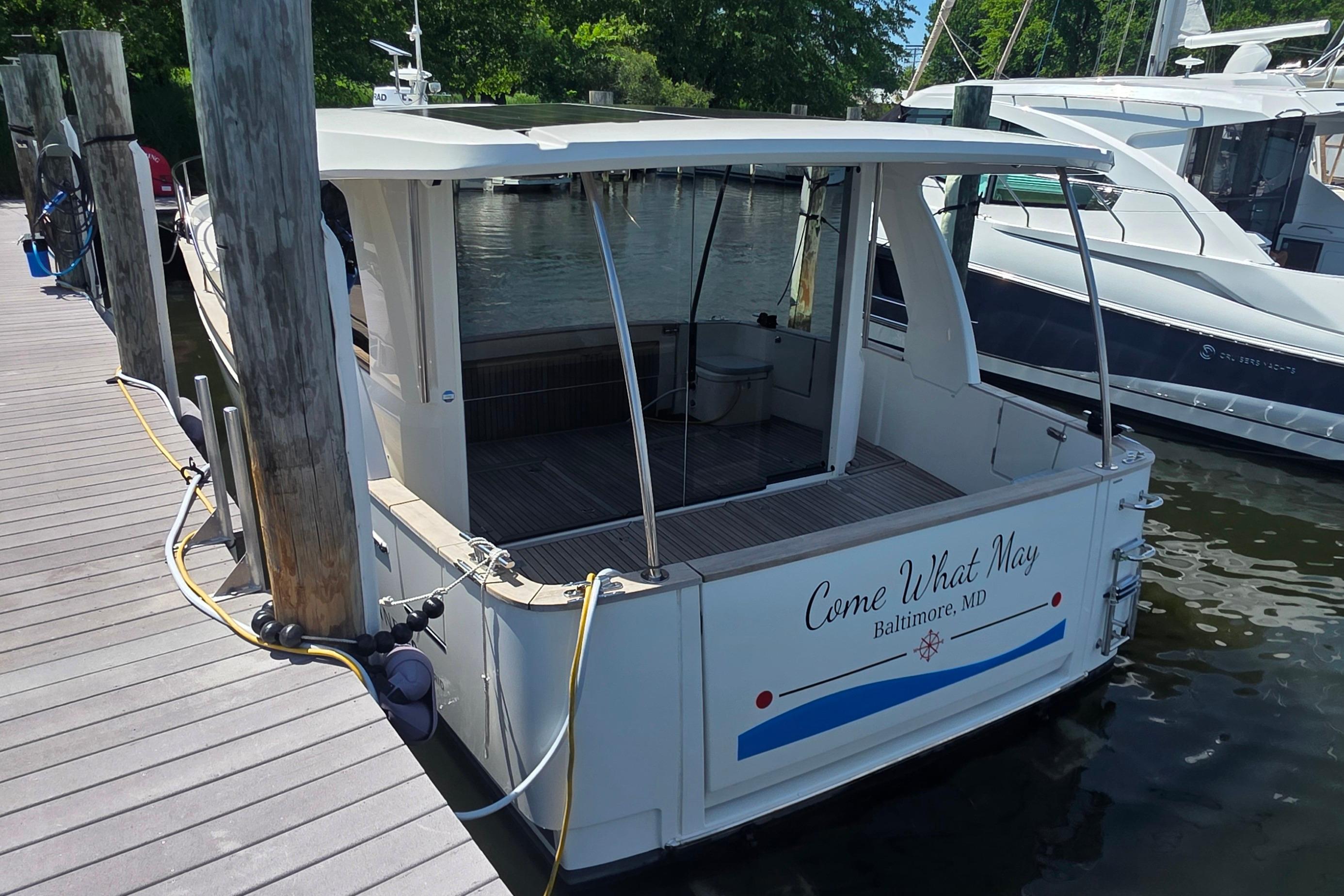 2023 Greenline 40 boat docked, rear view, named "Come What May," in Baltimore, MD.