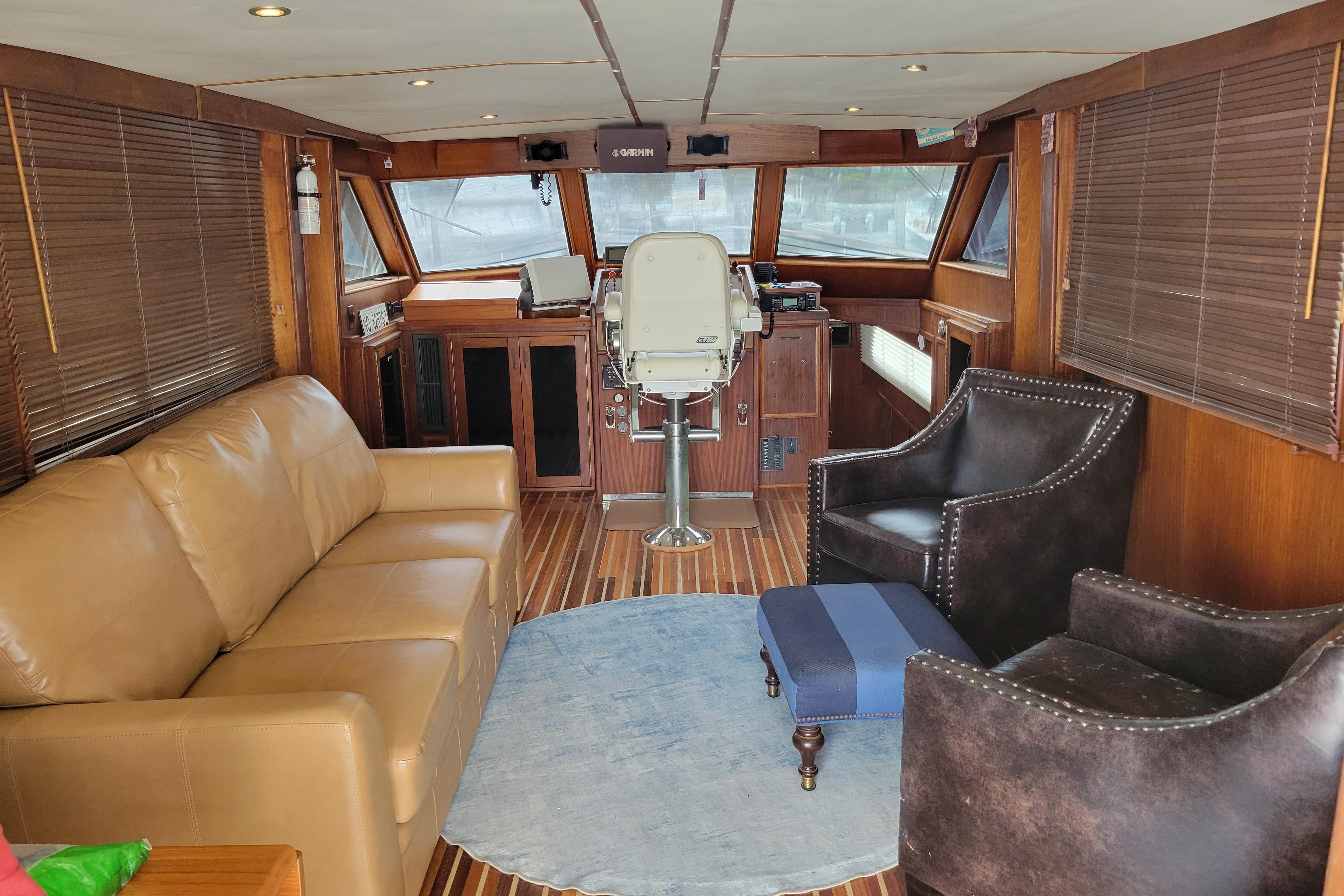 Interior of 1980 Hatteras 53 Yacht Fisherman with leather seating and wooden accents.