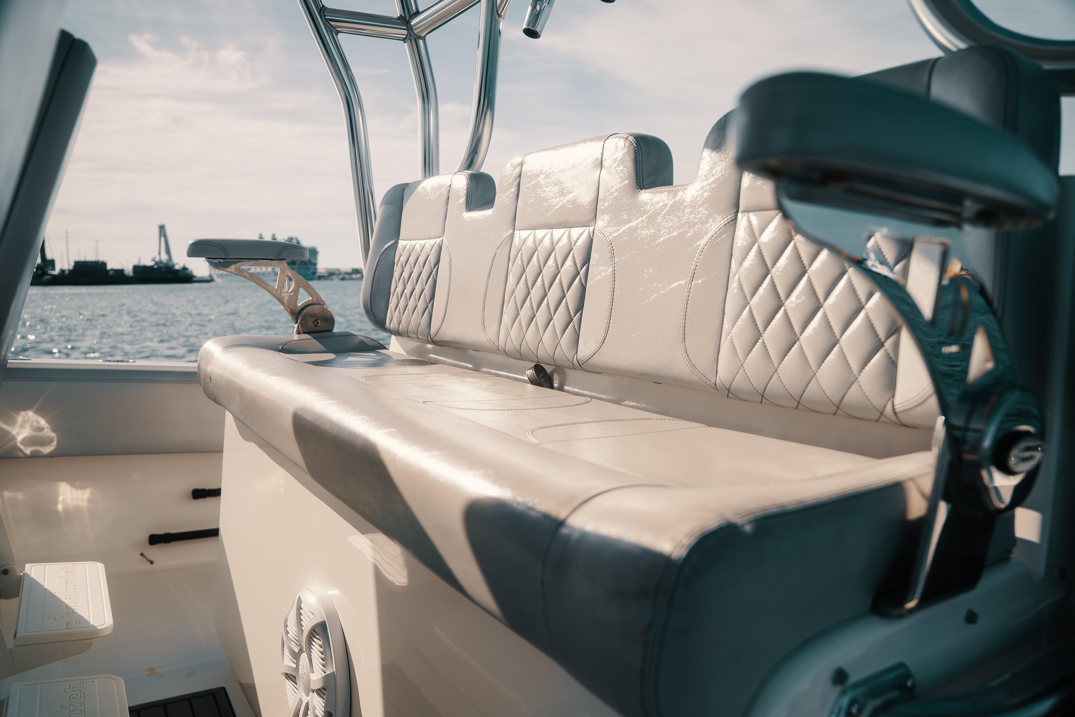 Luxurious seating on 2021 SeaHunter 41 CTS boat with quilted upholstery and ocean view.
