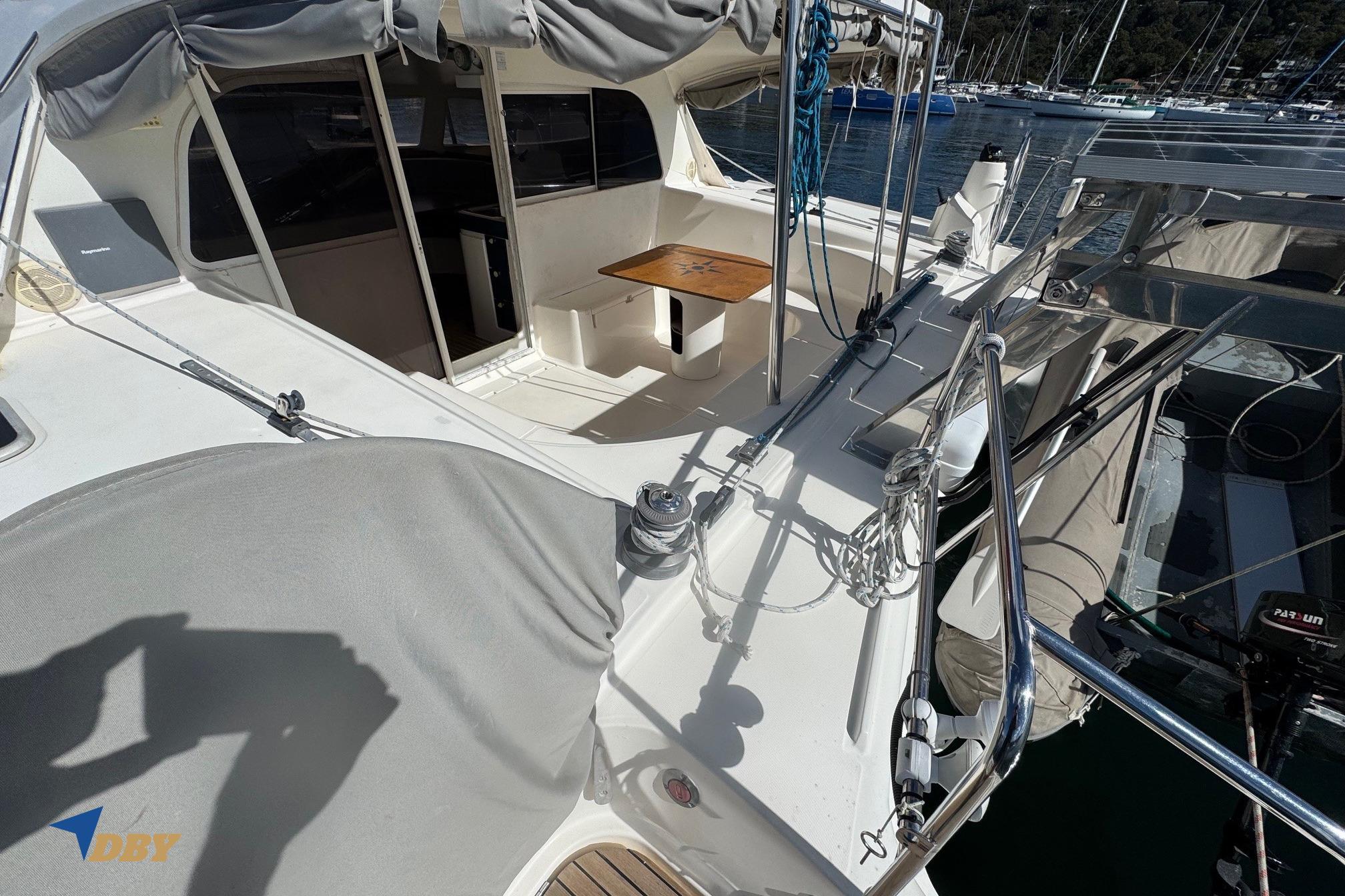 Nautitech 40 Open 2004 catamaran deck with seating area and marina view.