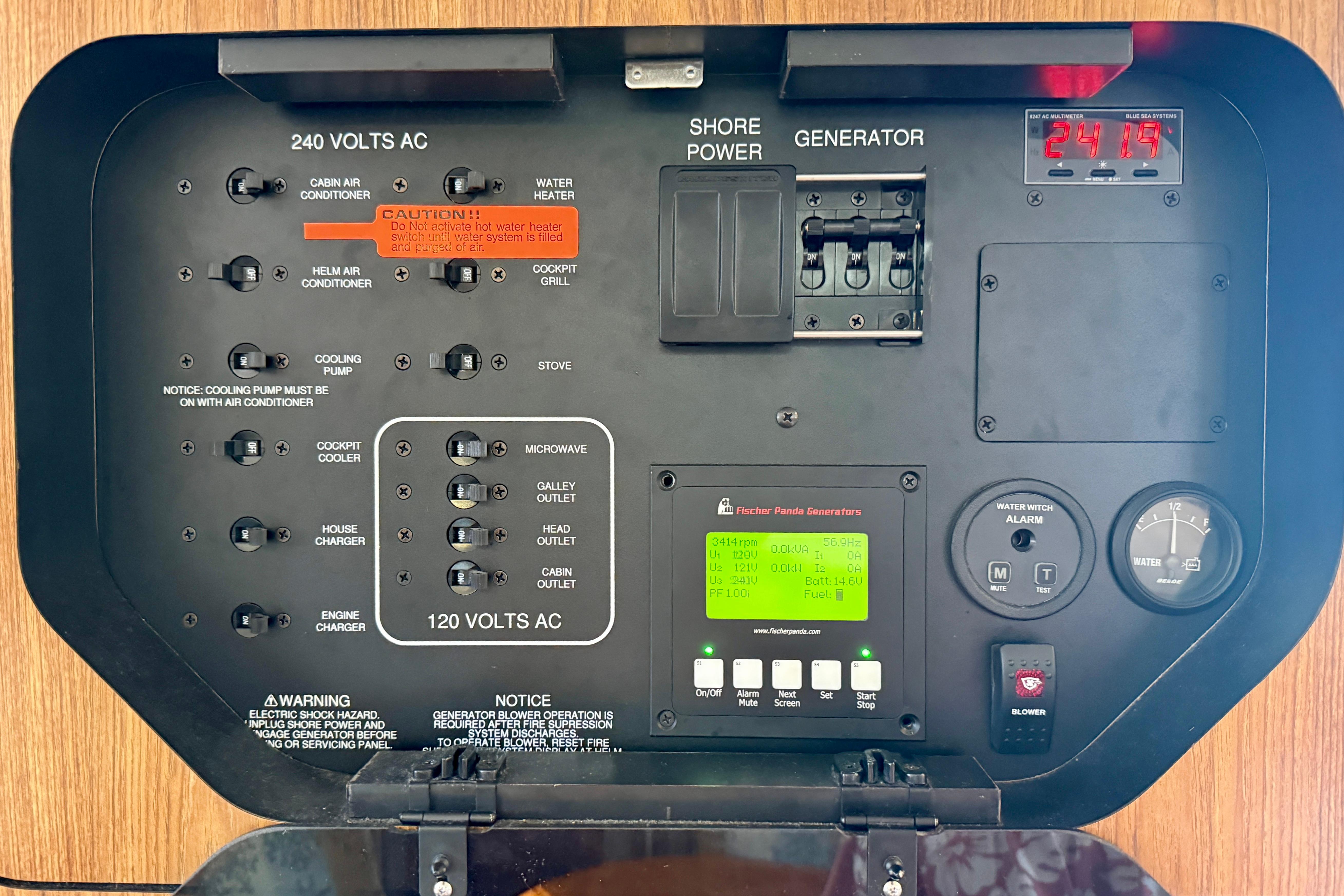 Control panel of a 2012 Pursuit OS 345 Offshore boat with generator and power switches.