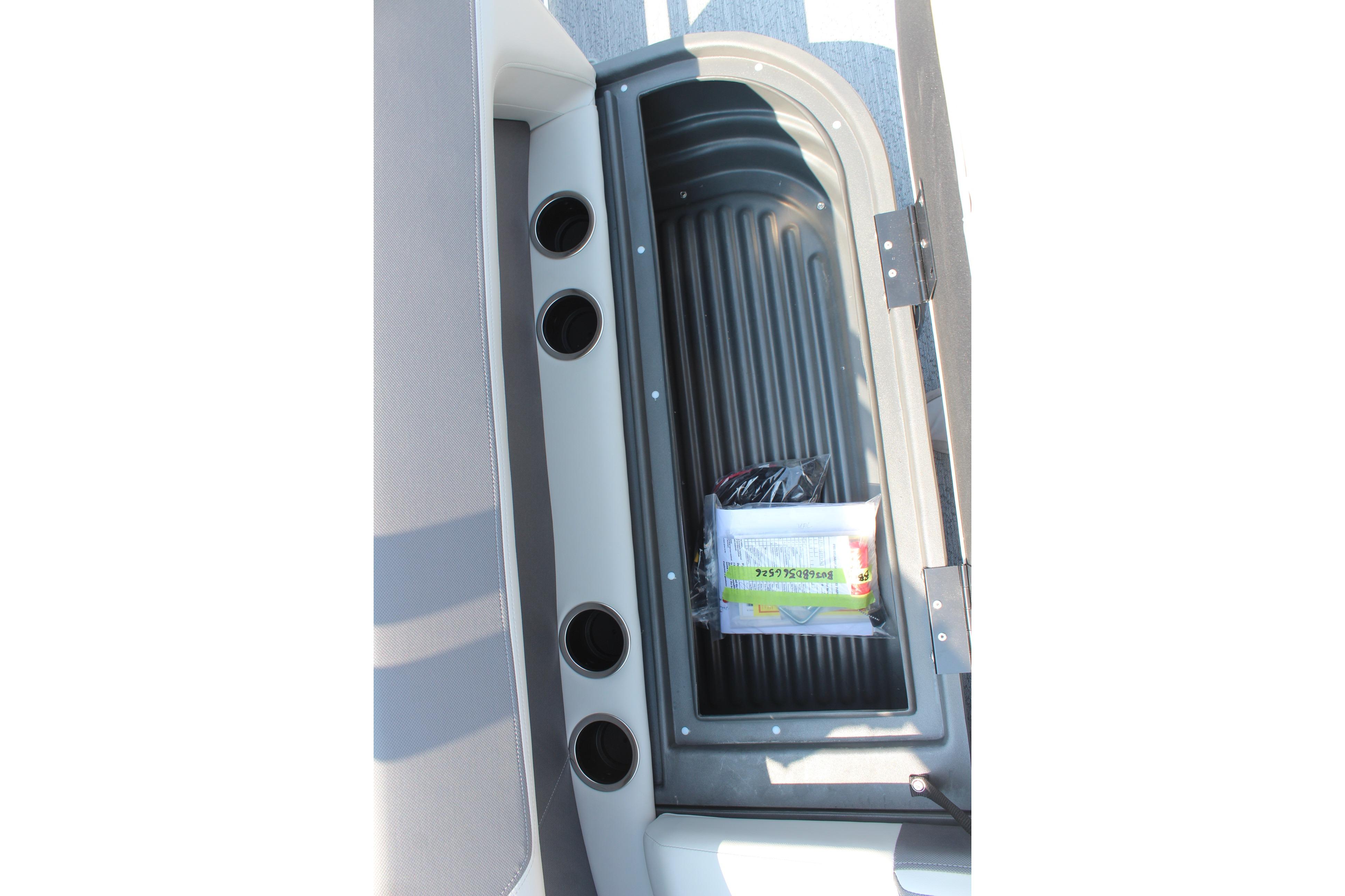 2026 Sun Tracker Bass Buggy 18 DLX storage compartment with cup holders and accessories.