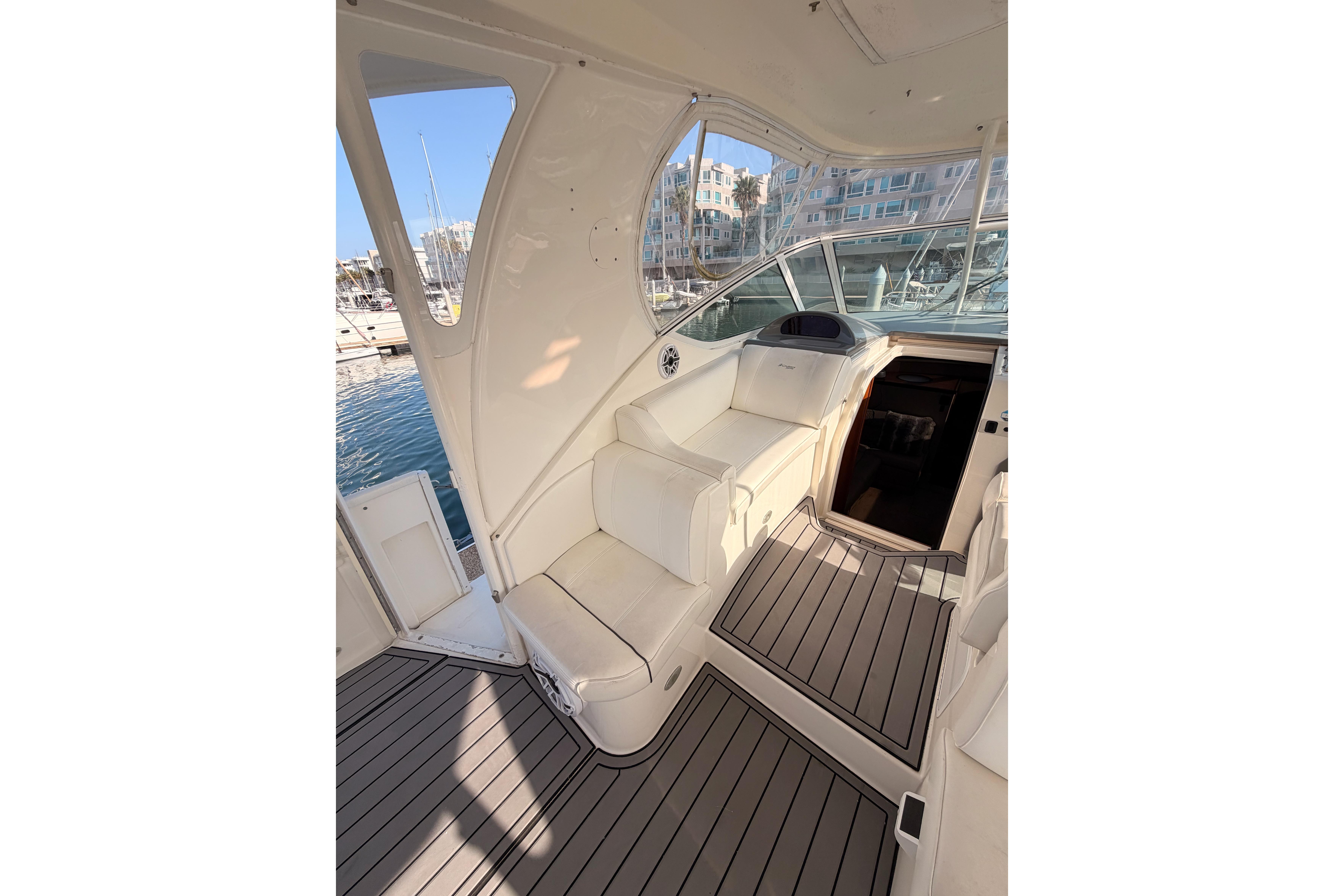 2005 Cruisers Yachts 405 Express Motoryacht interior with seating and marina view.
