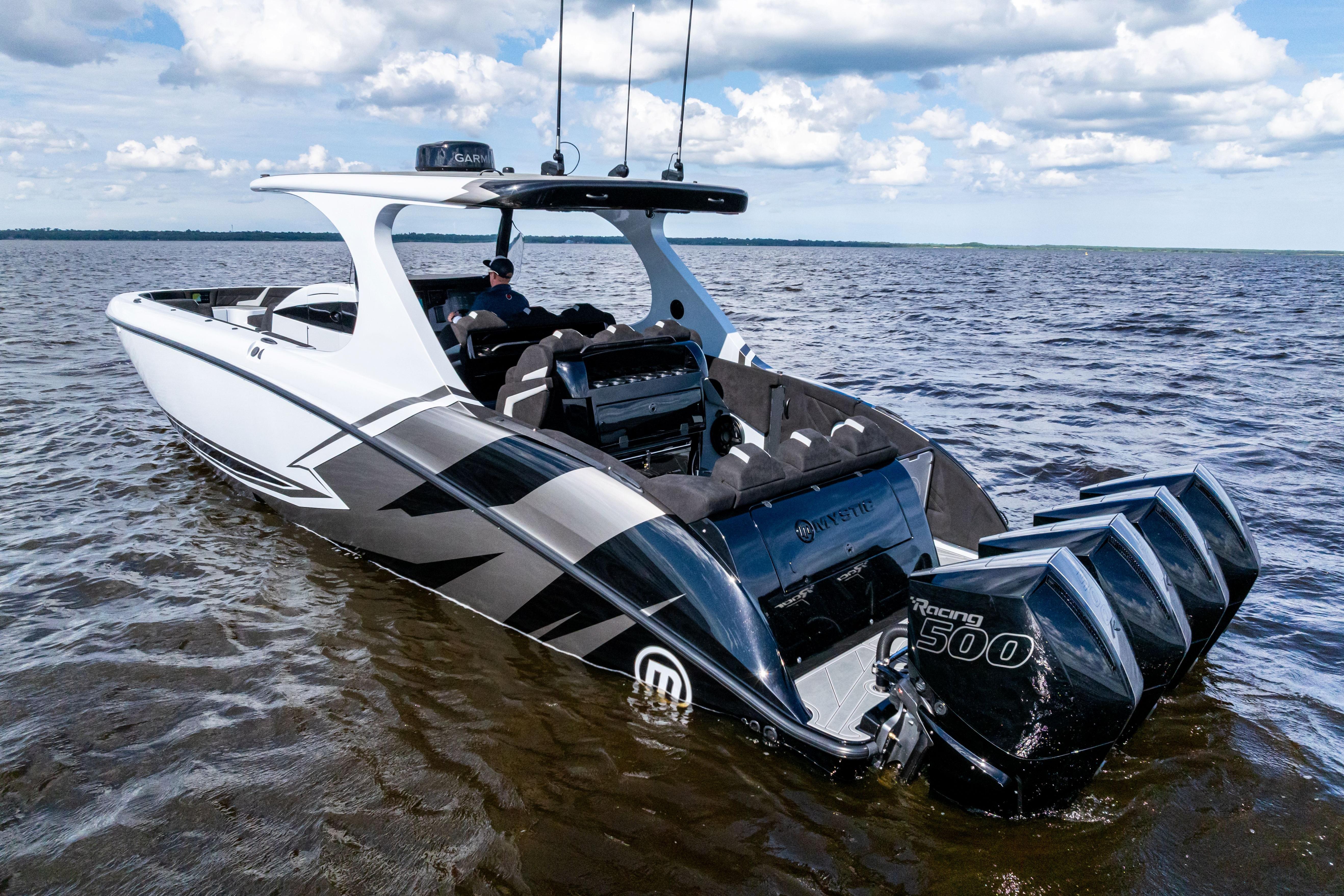 2027 Mystic Powerboats M4200 on water, featuring sleek design and powerful engines.