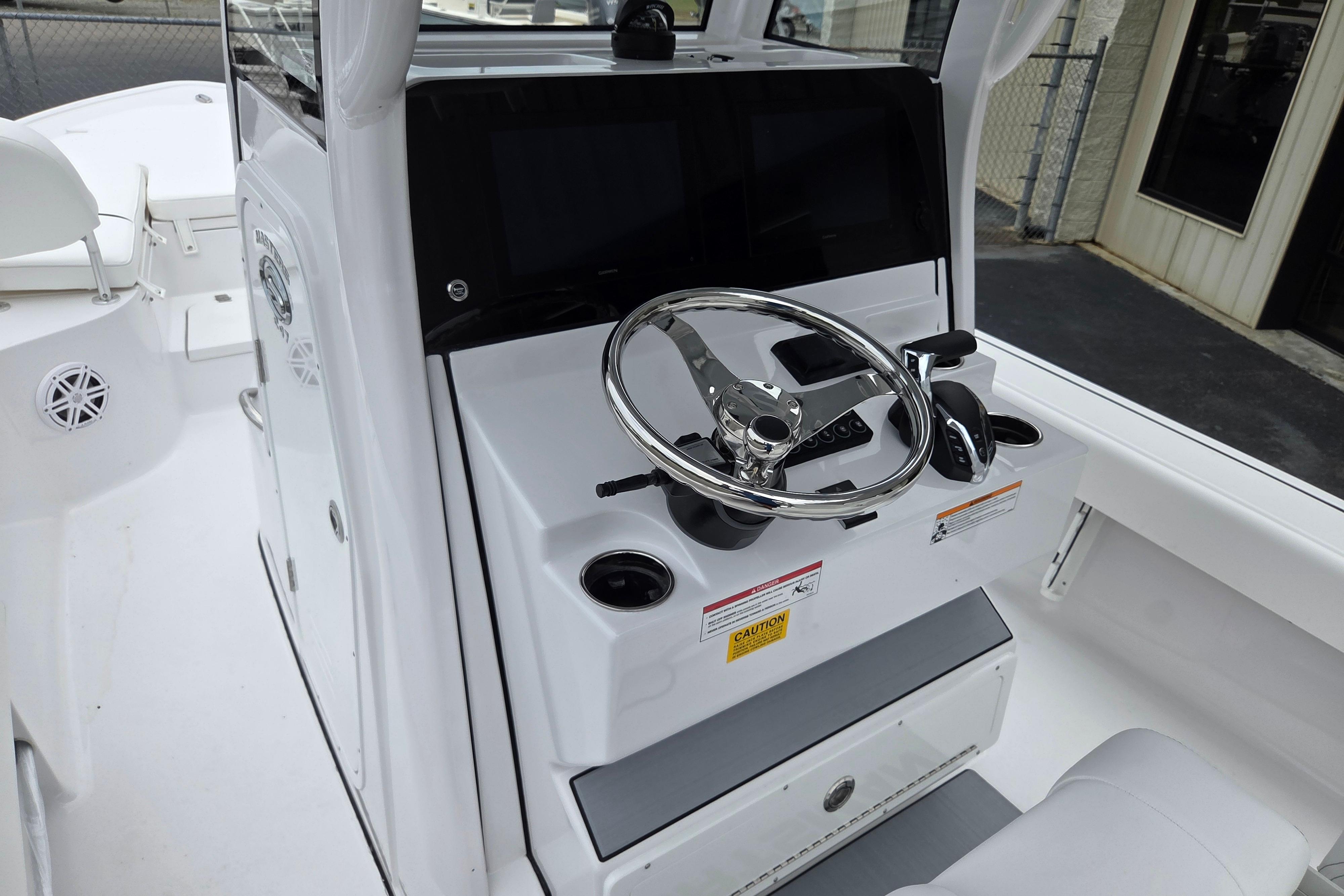 2026 Sportsman Masters 247 Bay Boat helm with steering wheel and controls.