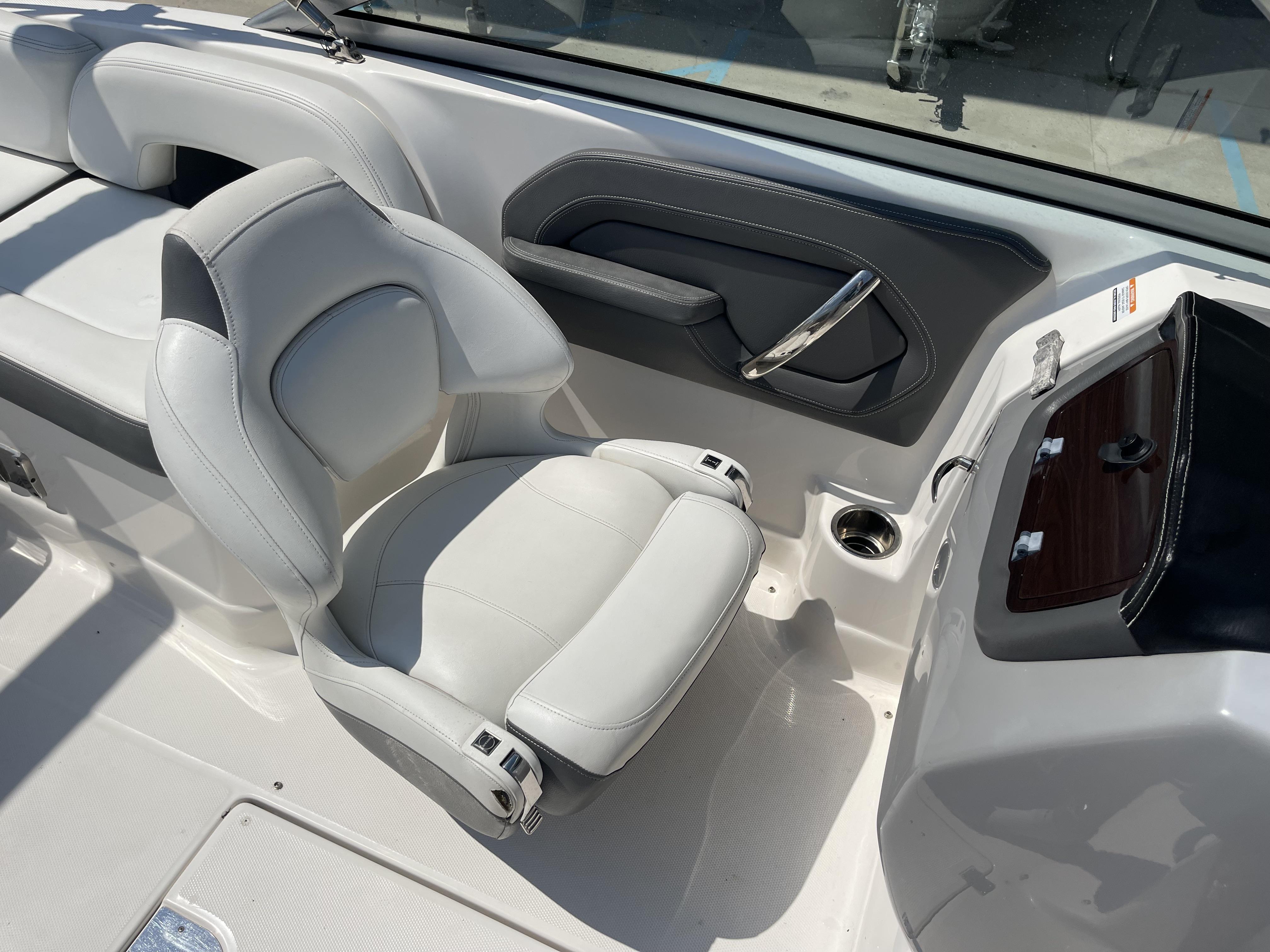 2014 Chaparral Sunesta 224 boat interior with white seating and sleek dashboard design.