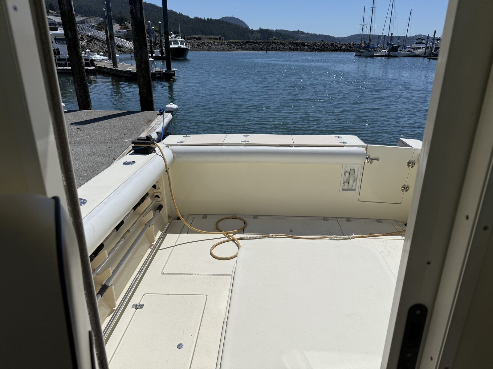 The boat is docked, overlooking the water with other boats in the background.