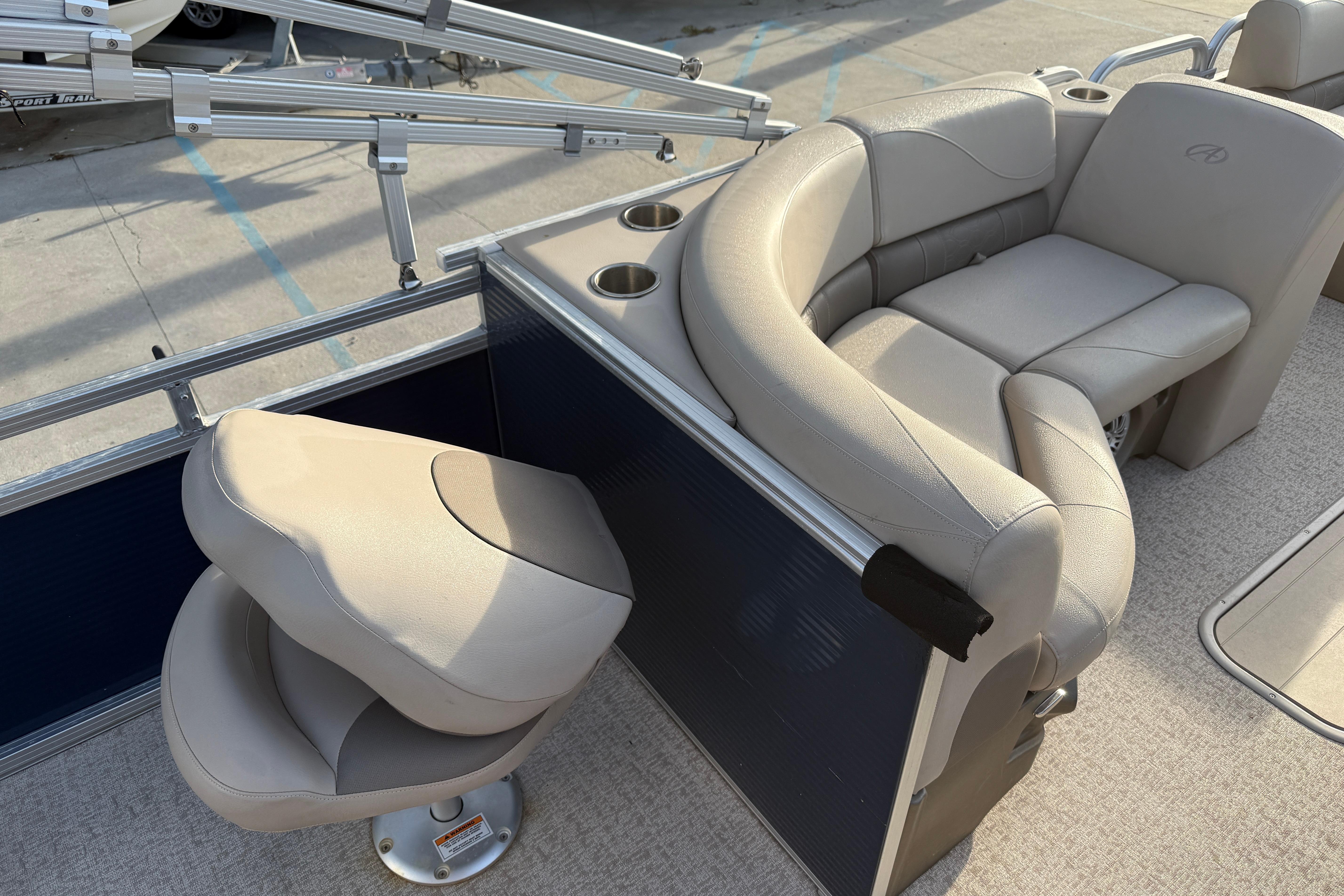 2019 Avalon Venture Fish N Cruise boat interior with beige seating and cup holders.