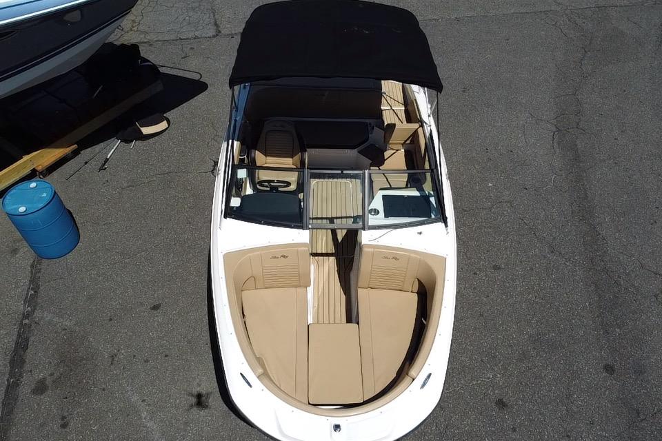 2021 Sea Ray SPX 190 boat with beige interior and black canopy, aerial view.