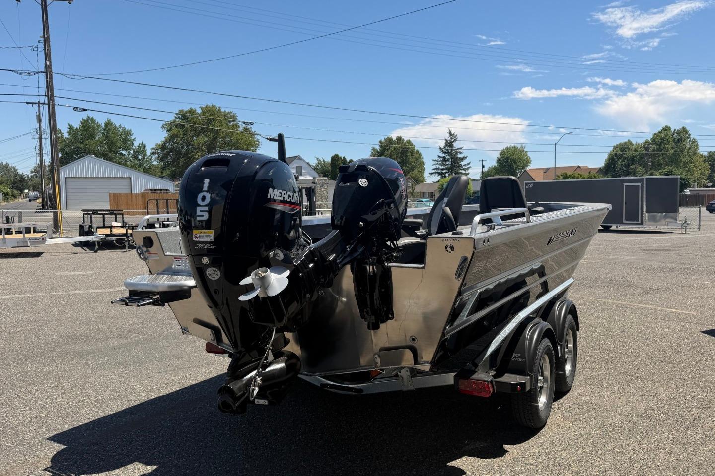 2026 Thunder Jet 209 Rush OT boat with dual Mercury engines in a parking lot.