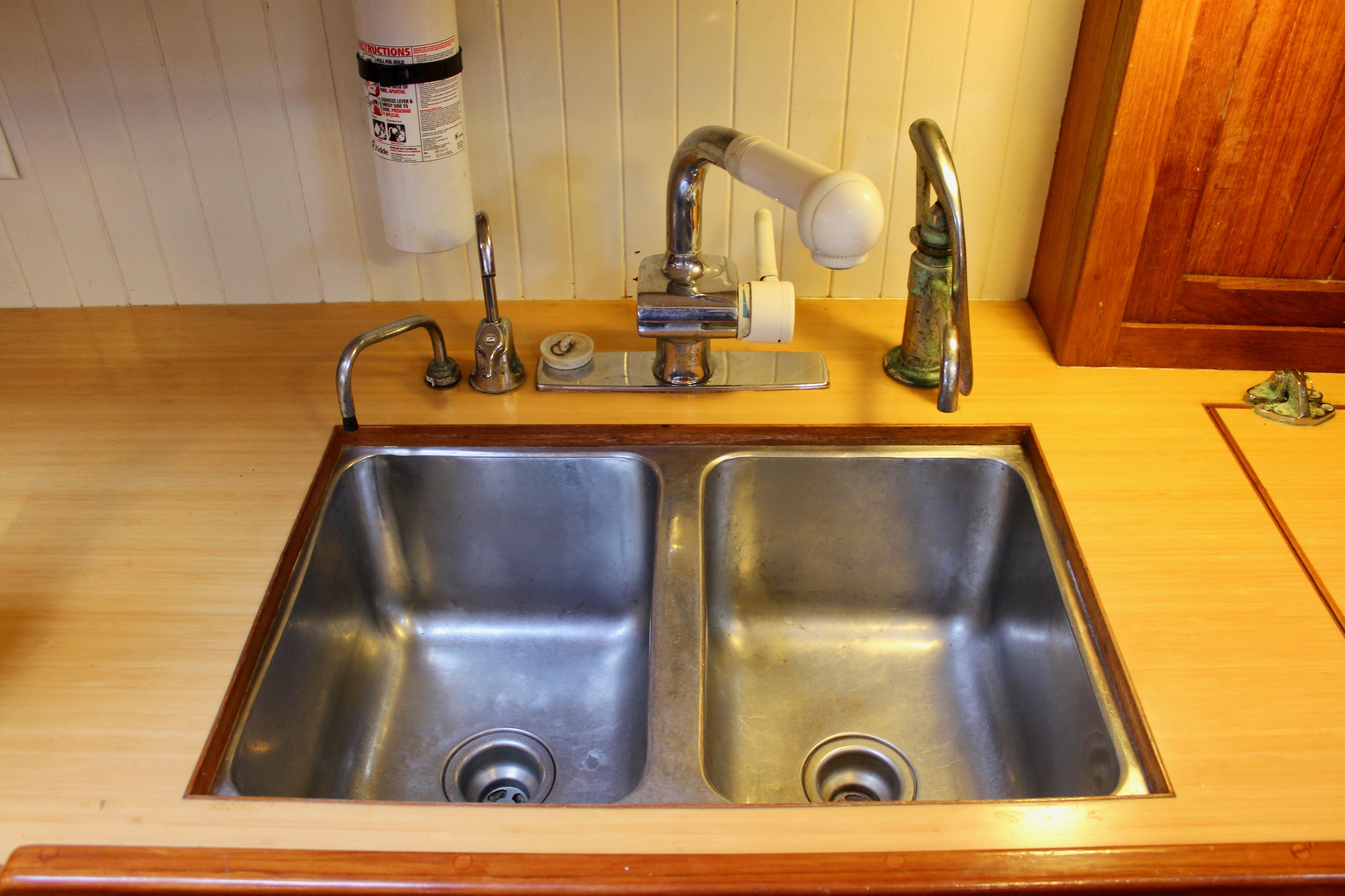 Double stainless steel sink in a 1981 Kelly Peterson 46 yacht kitchen.