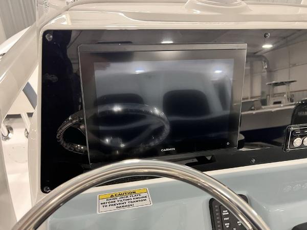 2025 Tidewater 2300 Carolina Bay boat dashboard with Garmin display and steering wheel.