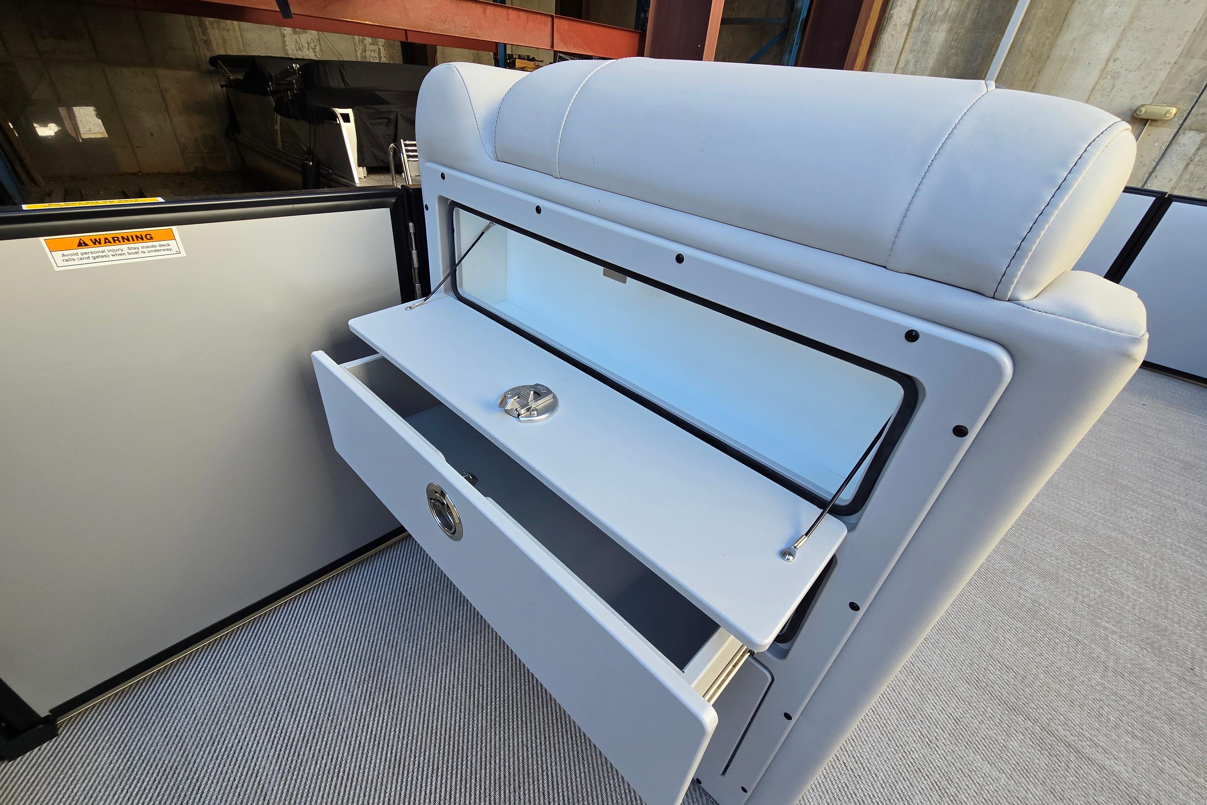 2024 Godfrey Sweetwater 2486 SB boat interior with open storage compartment and seating.