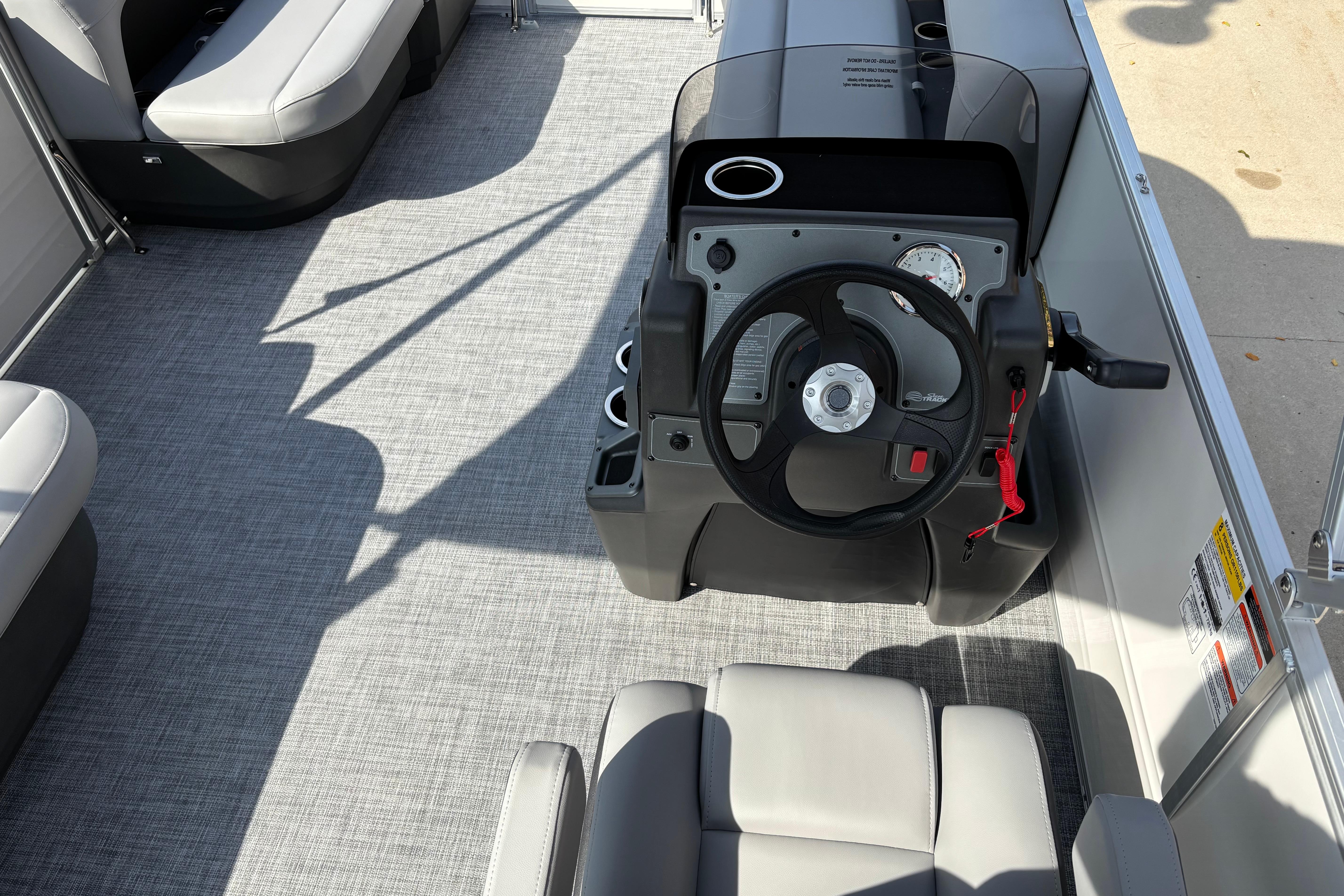 2026 Sun Tracker Party Barge 16 DLX interior with steering console and seating.