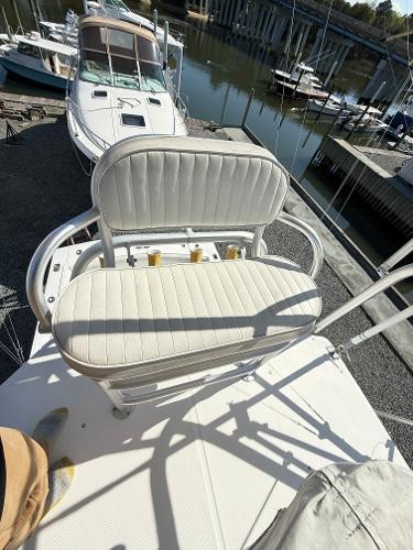 2001 Albemarle 280 Express Sport Fisherman boat with white cushioned seating, docked near other boats.