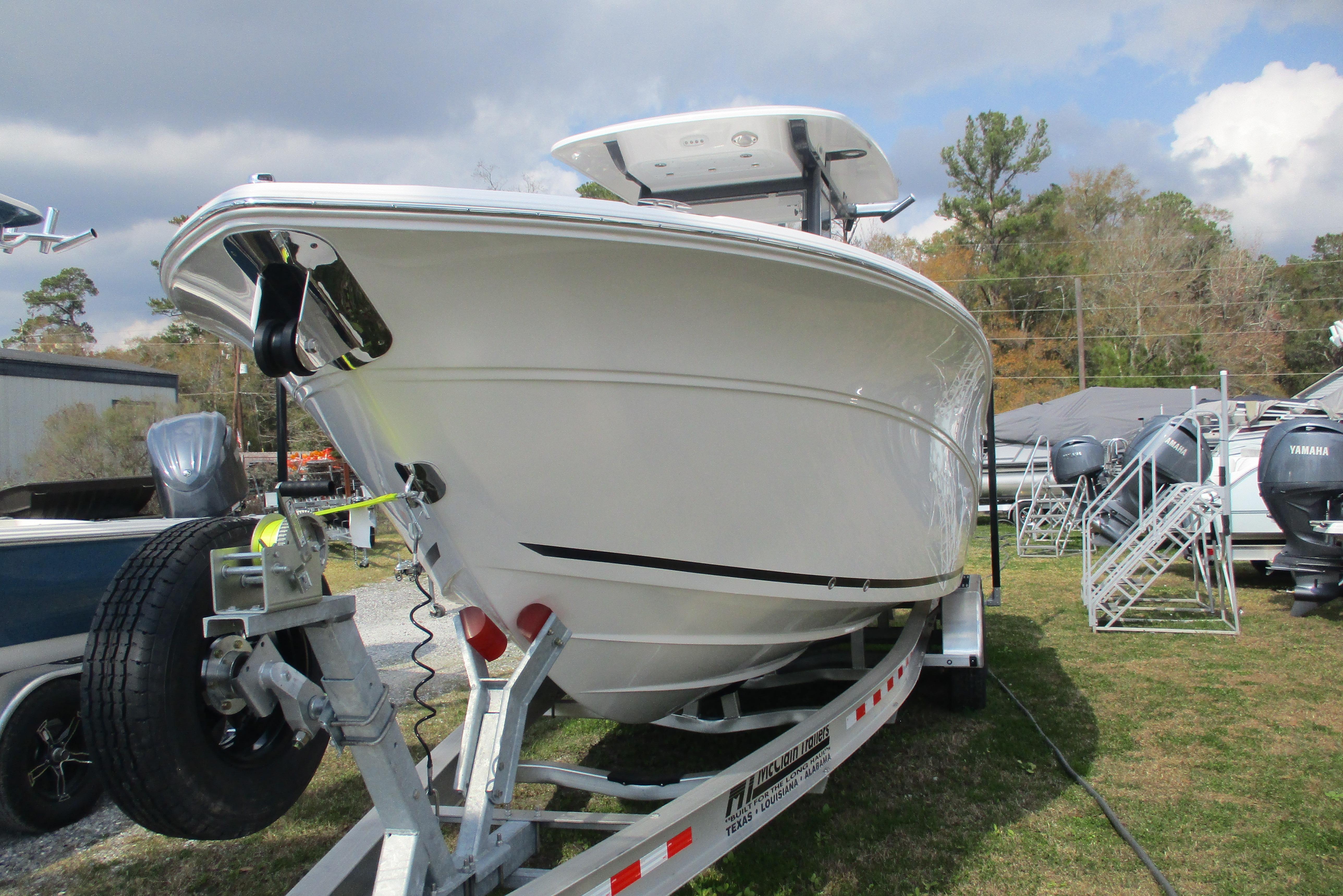 2026 Sea Fox 268 Commander boat on trailer, displayed outdoors under cloudy sky.