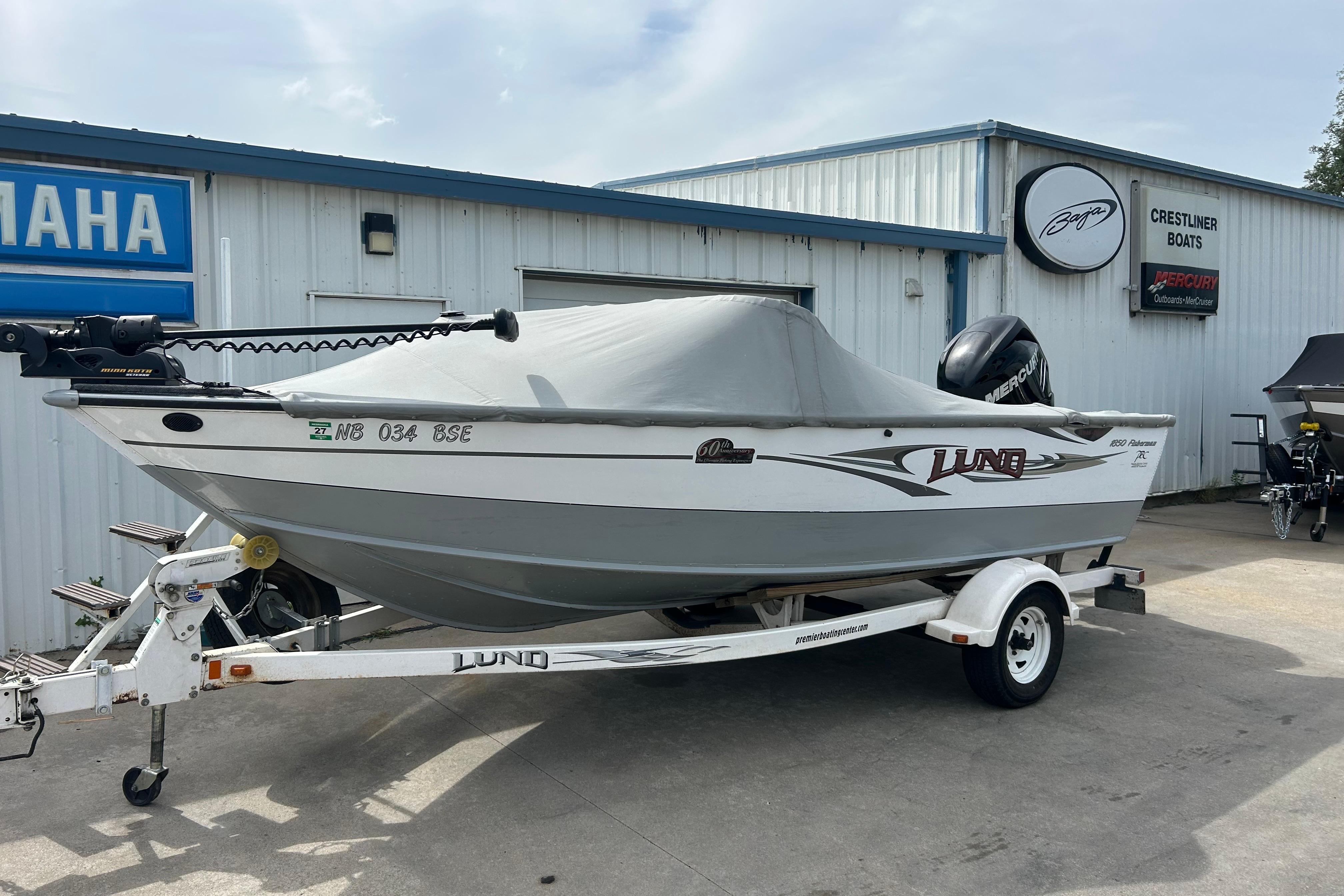 2008 Lund 1850 Fisherman boat on trailer, parked outside Crestliner Boats dealership.