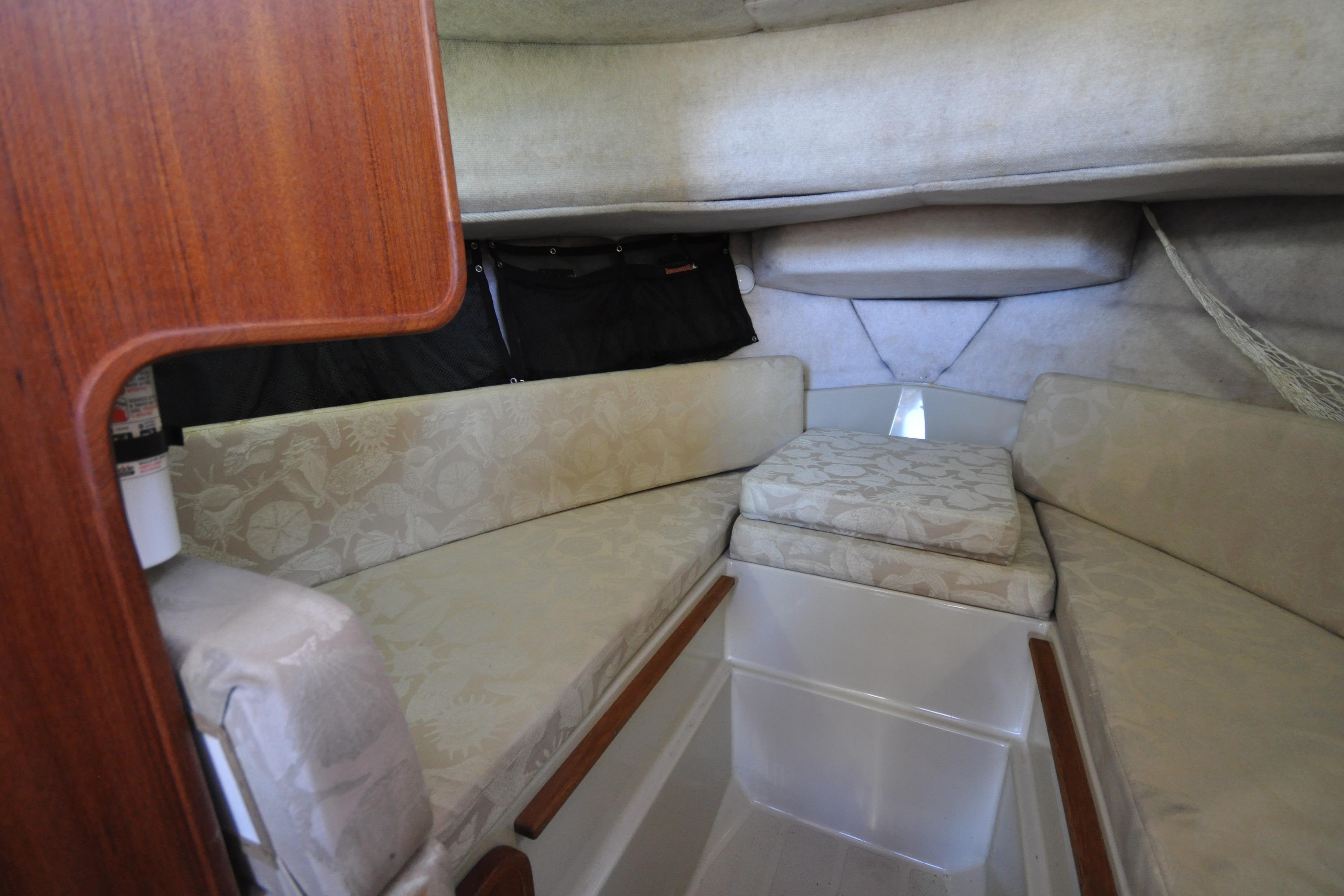 Interior cabin of 2007 Ranger Tug R-25 with cushioned seating and wooden accents.