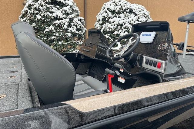 2026 Nitro Z19 XL boat interior with steering wheel and control panel, snowy background.