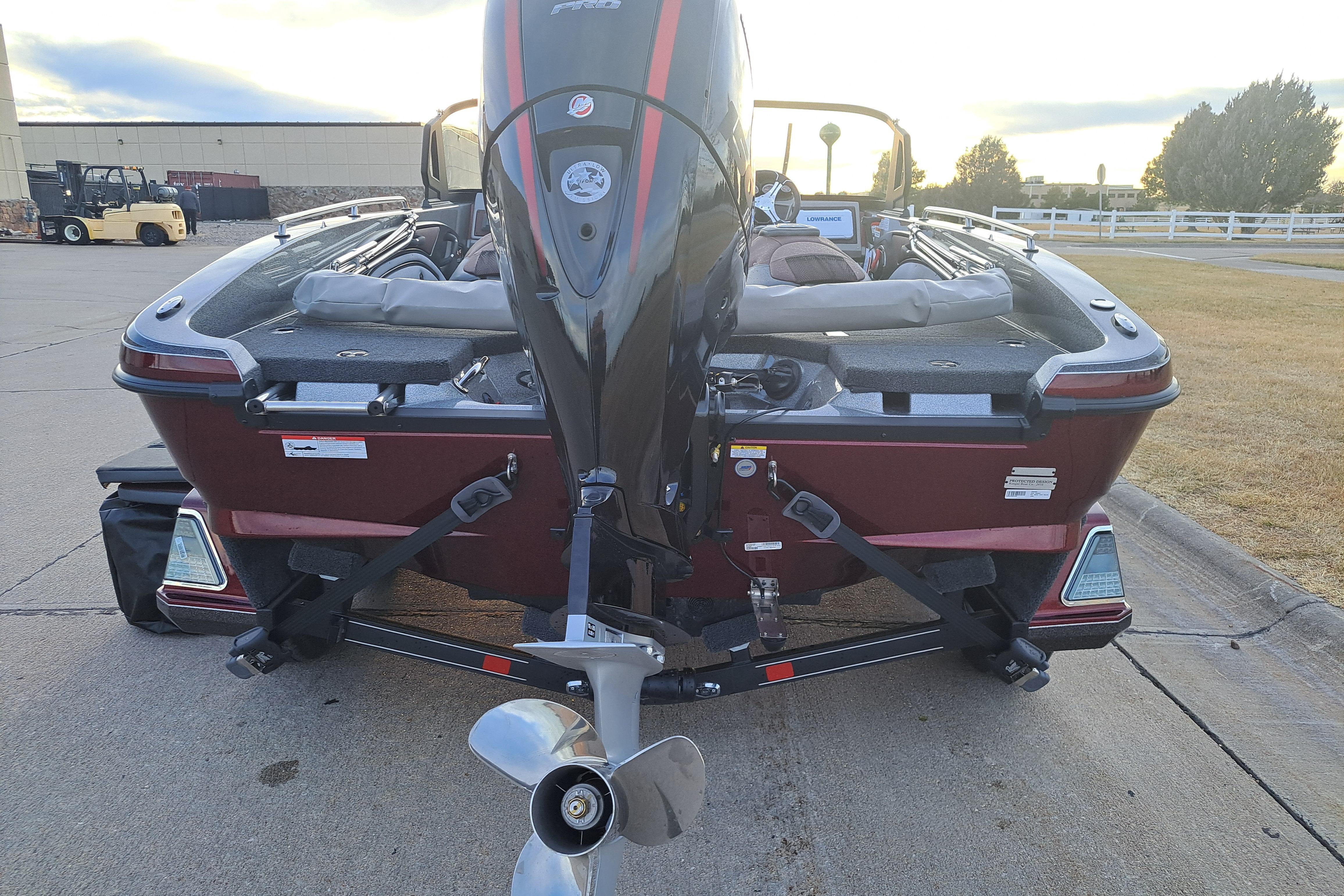 2026 Ranger 1850MS boat with outboard motor, parked on a concrete surface.