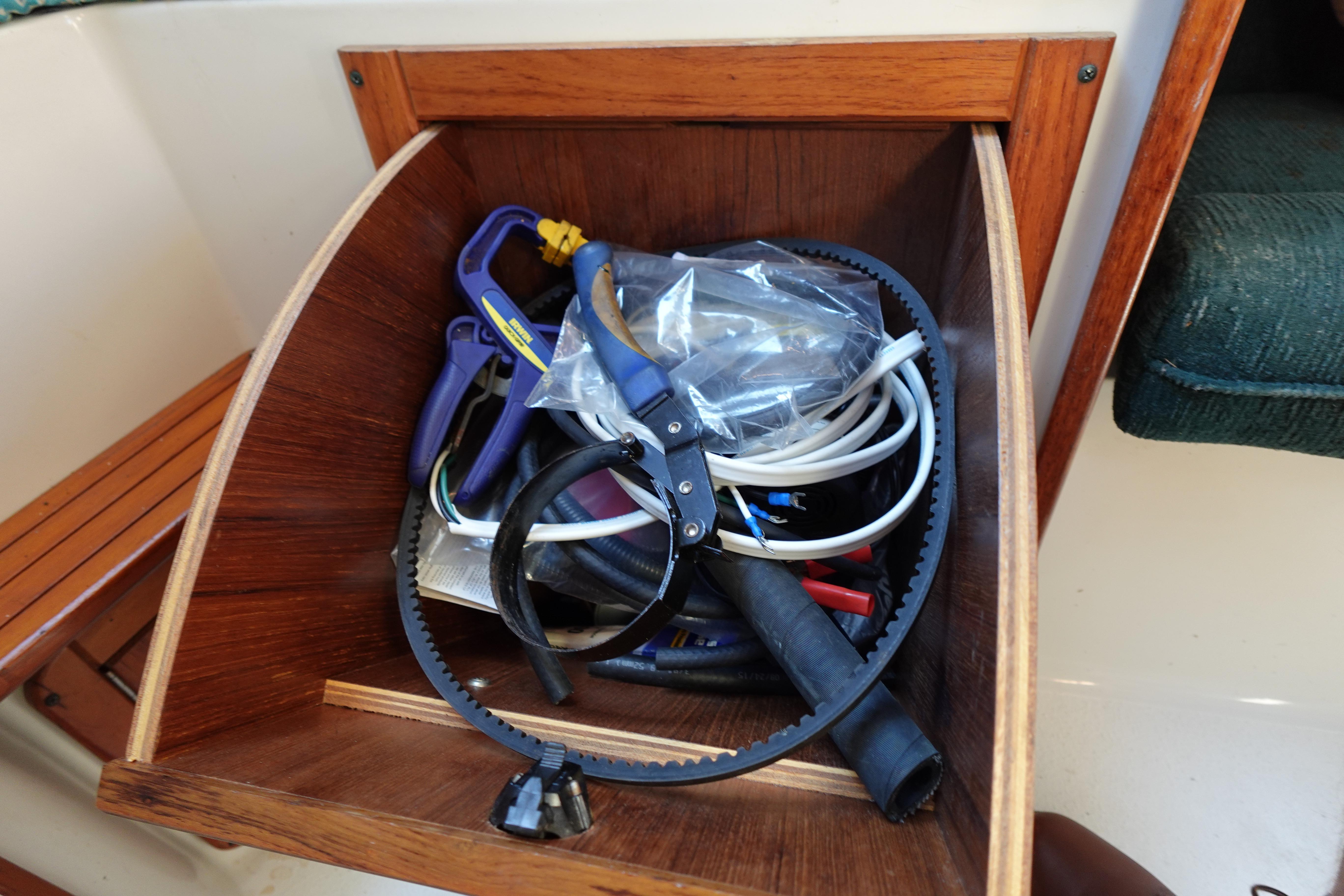 Tool storage on a 1997 Catalina 28 sailboat, featuring various maintenance items.