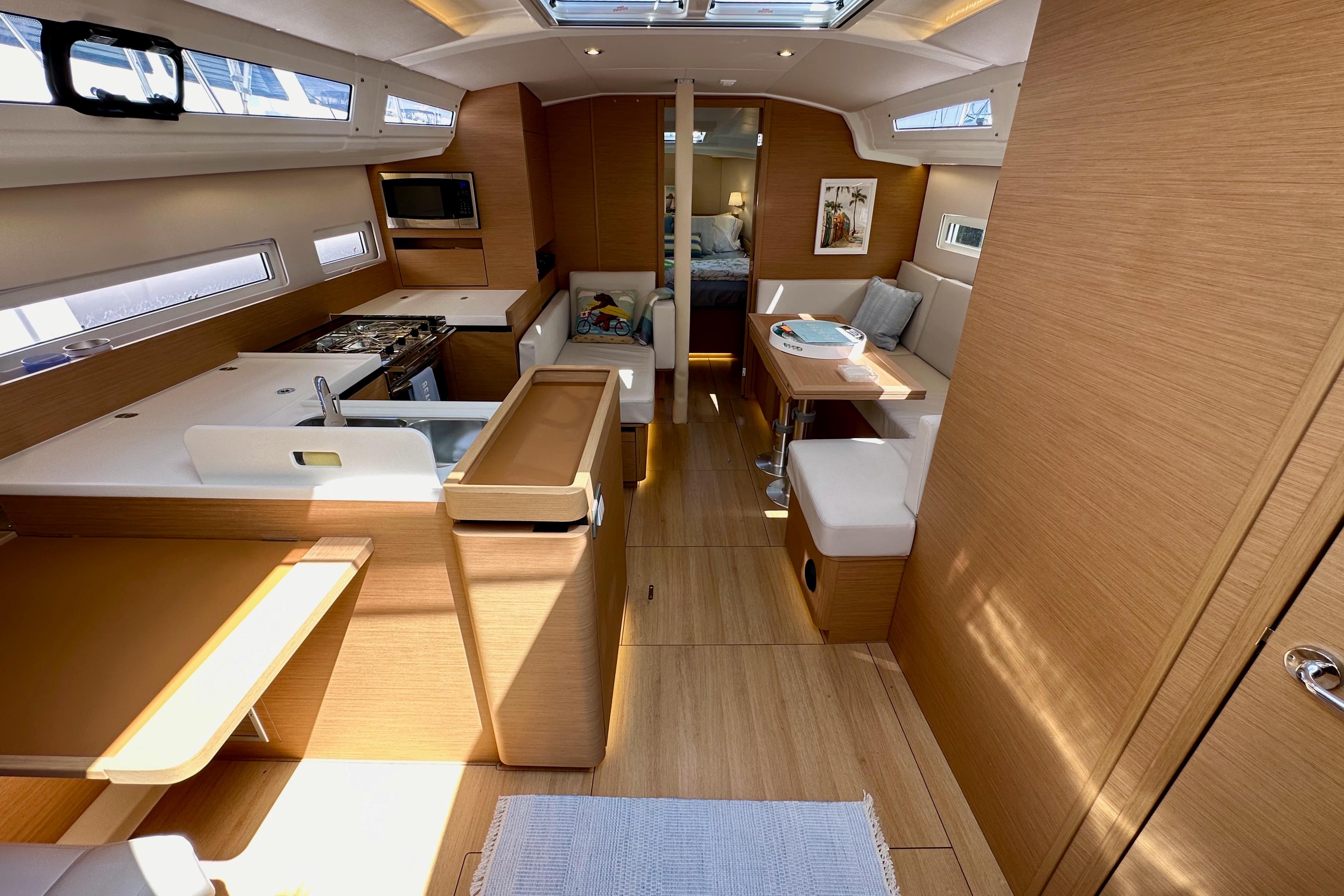 Interior of 2024 Jeanneau Sun Odyssey 410 sailboat, featuring modern wood finish and spacious layout.