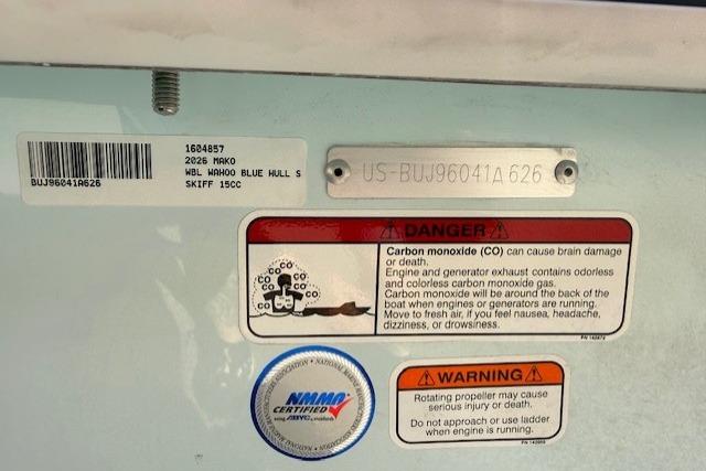 2026 Mako Pro Skiff 15 CC warning labels and certification badge on blue hull.