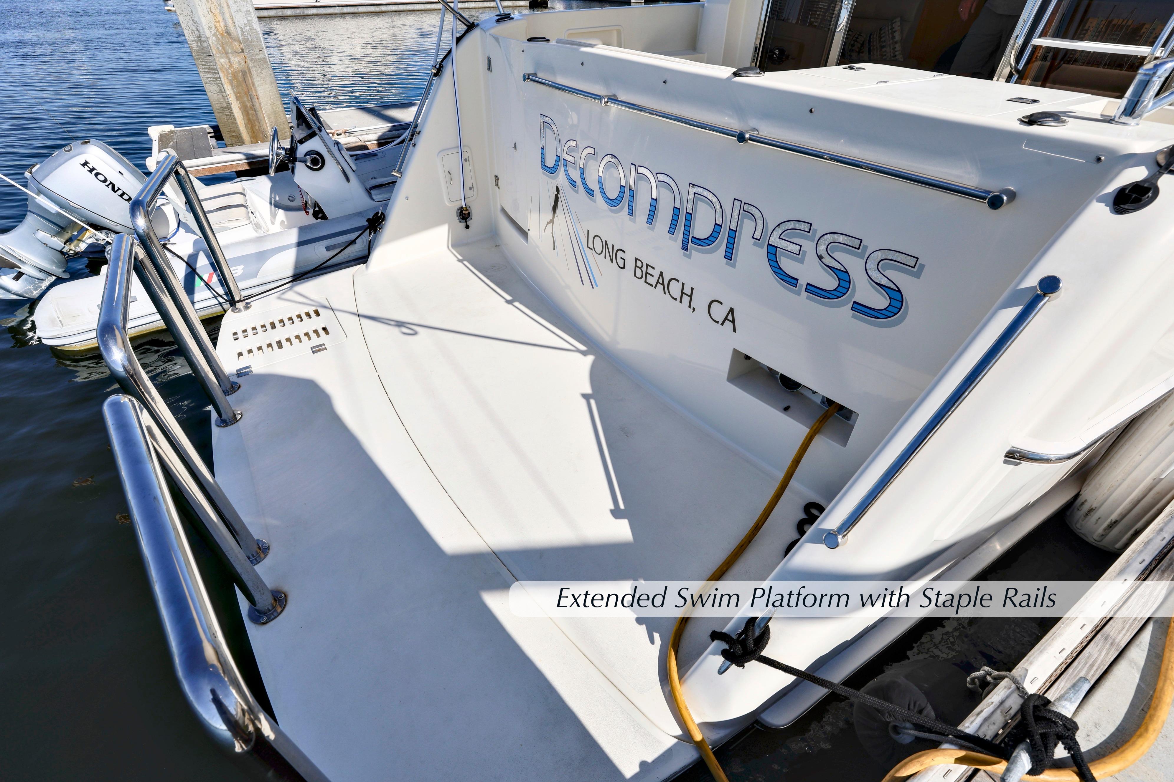 2004 McKinna 57 Pilothouse with extended swim platform and staple rails, docked in Long Beach, CA.