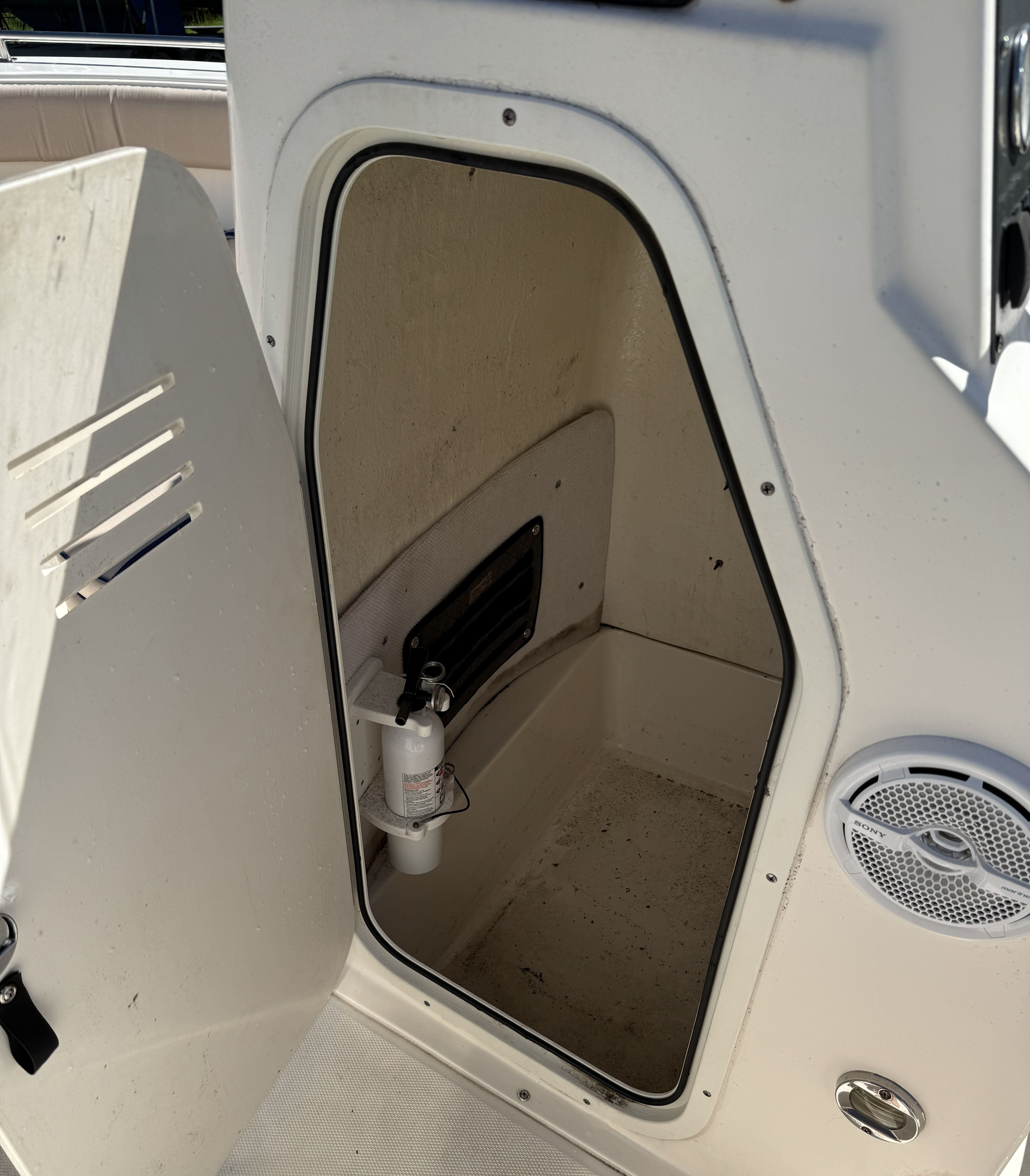 Open storage compartment in a 2004 Sea Hunt Triton boat.