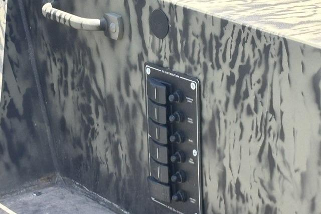 Control panel on 2026 Tracker Grizzly 1860 Utility boat with camouflage design.