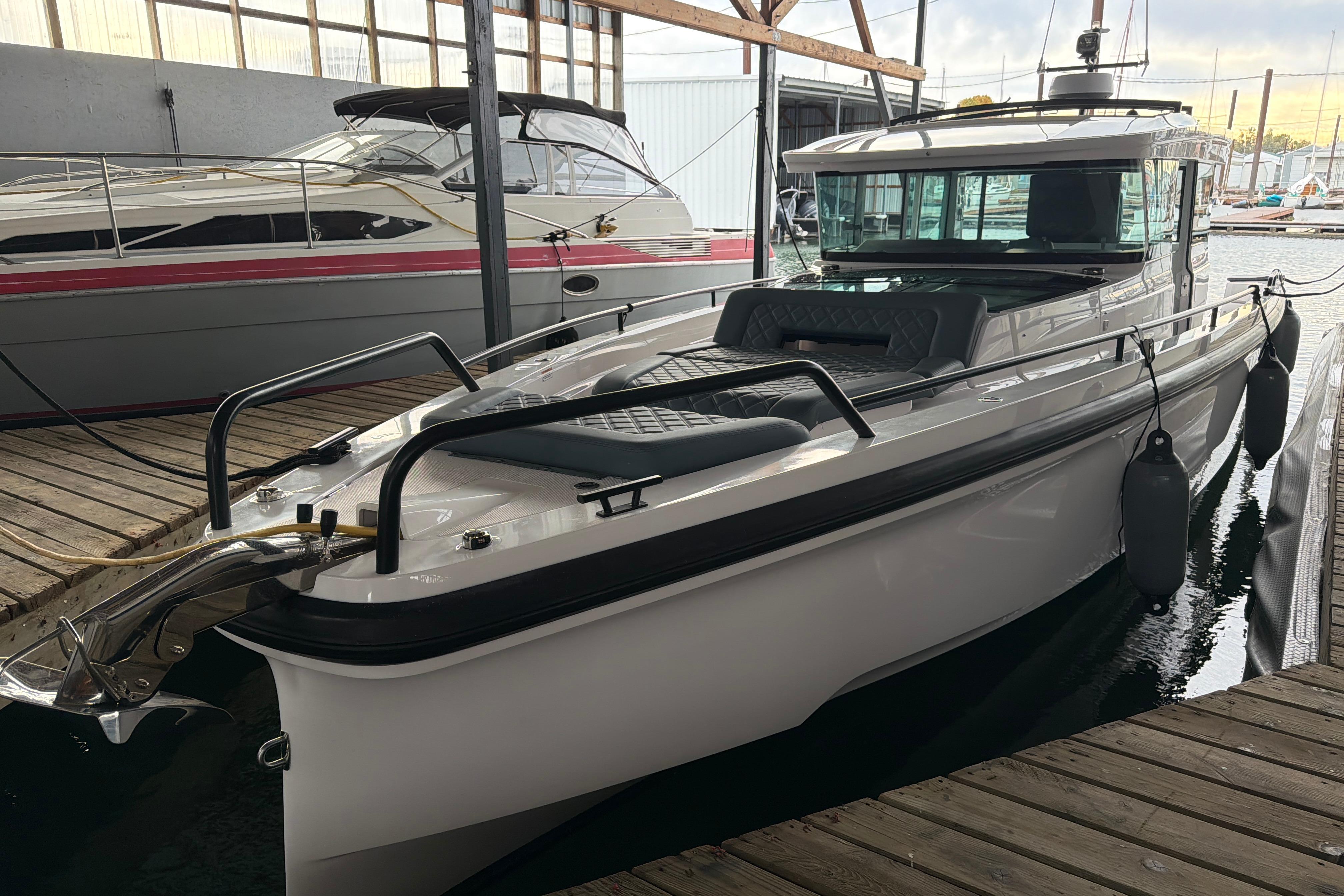2022 Axopar Brabus 37 XC Cross Cabin docked in a marina.