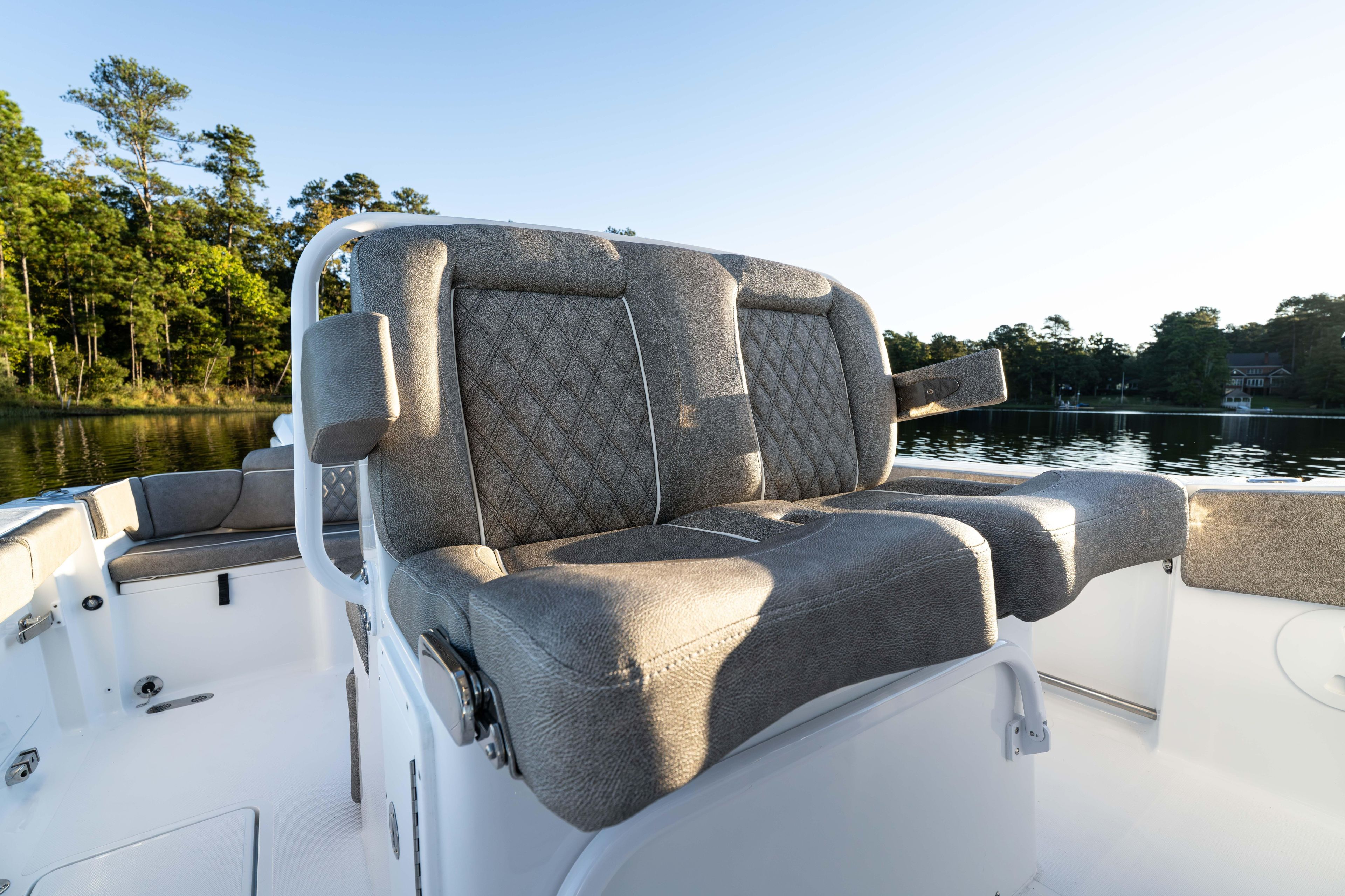 2026 Sea Hunt Ultra 275 Coffin Box boat interior with cushioned seating, lake view.
