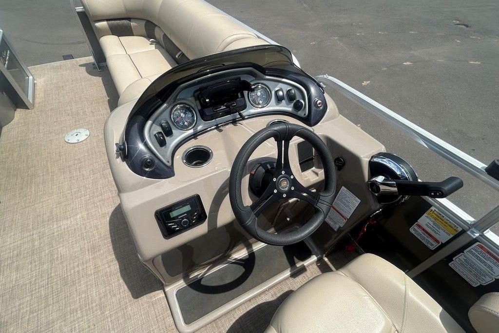 2023 Sun Tracker Party Barge 22 DLX helm with steering wheel and control panel.