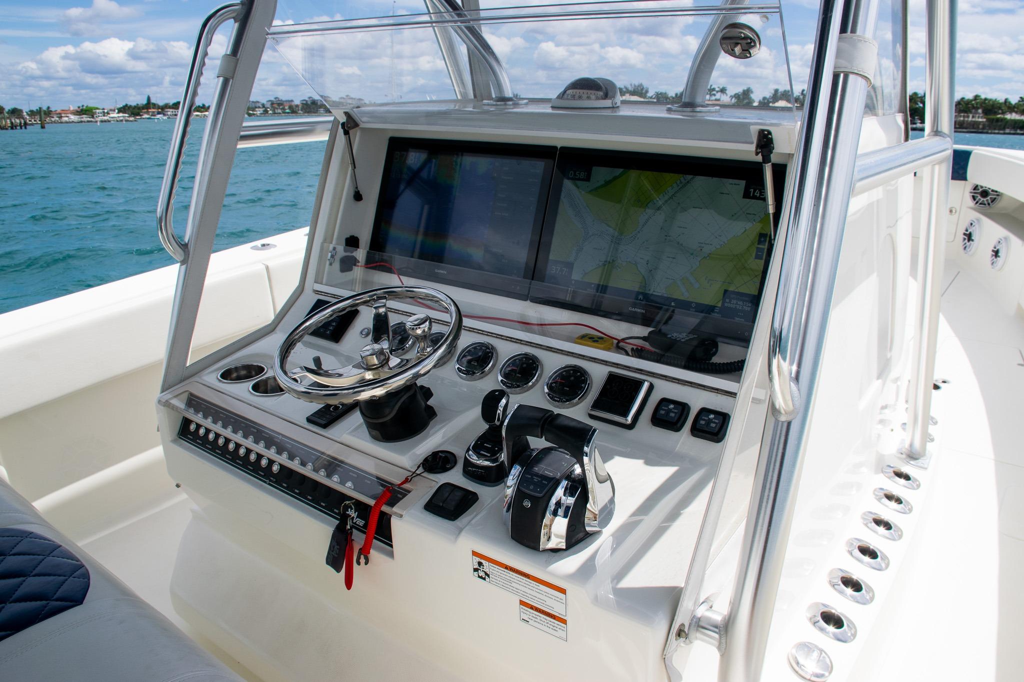 2022 SeaVee 390Z boat console with steering wheel and navigation screens.