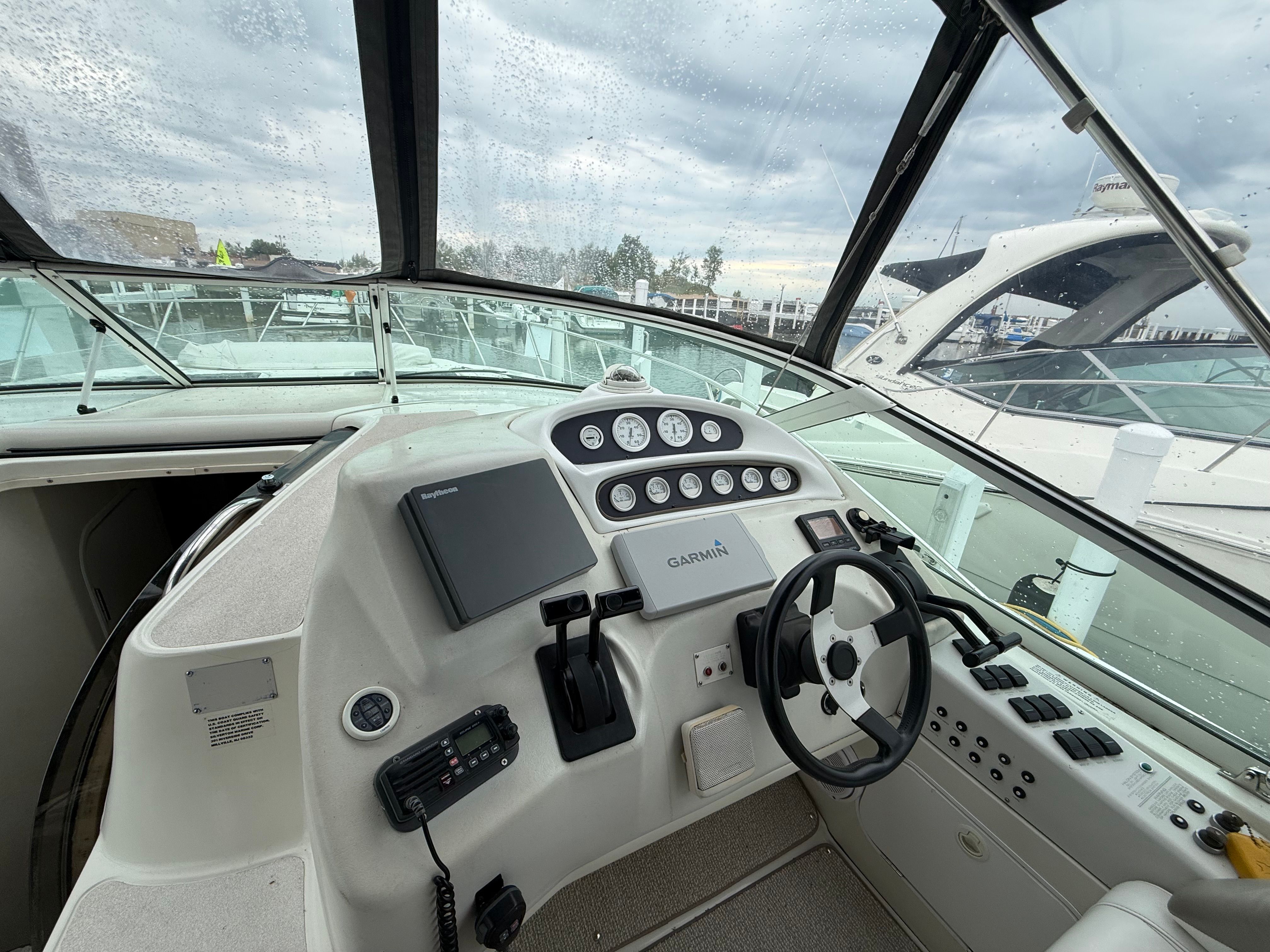The image shows the helm of a 1995 Silverton 360 with modern electronics.