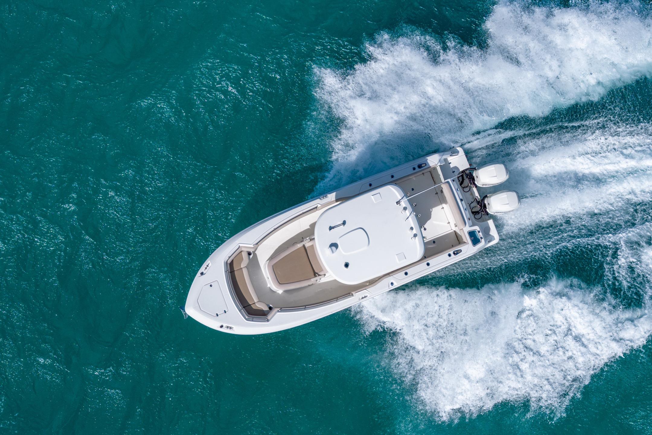 2016 Boston Whaler 280 Outrage cruising on clear blue water.