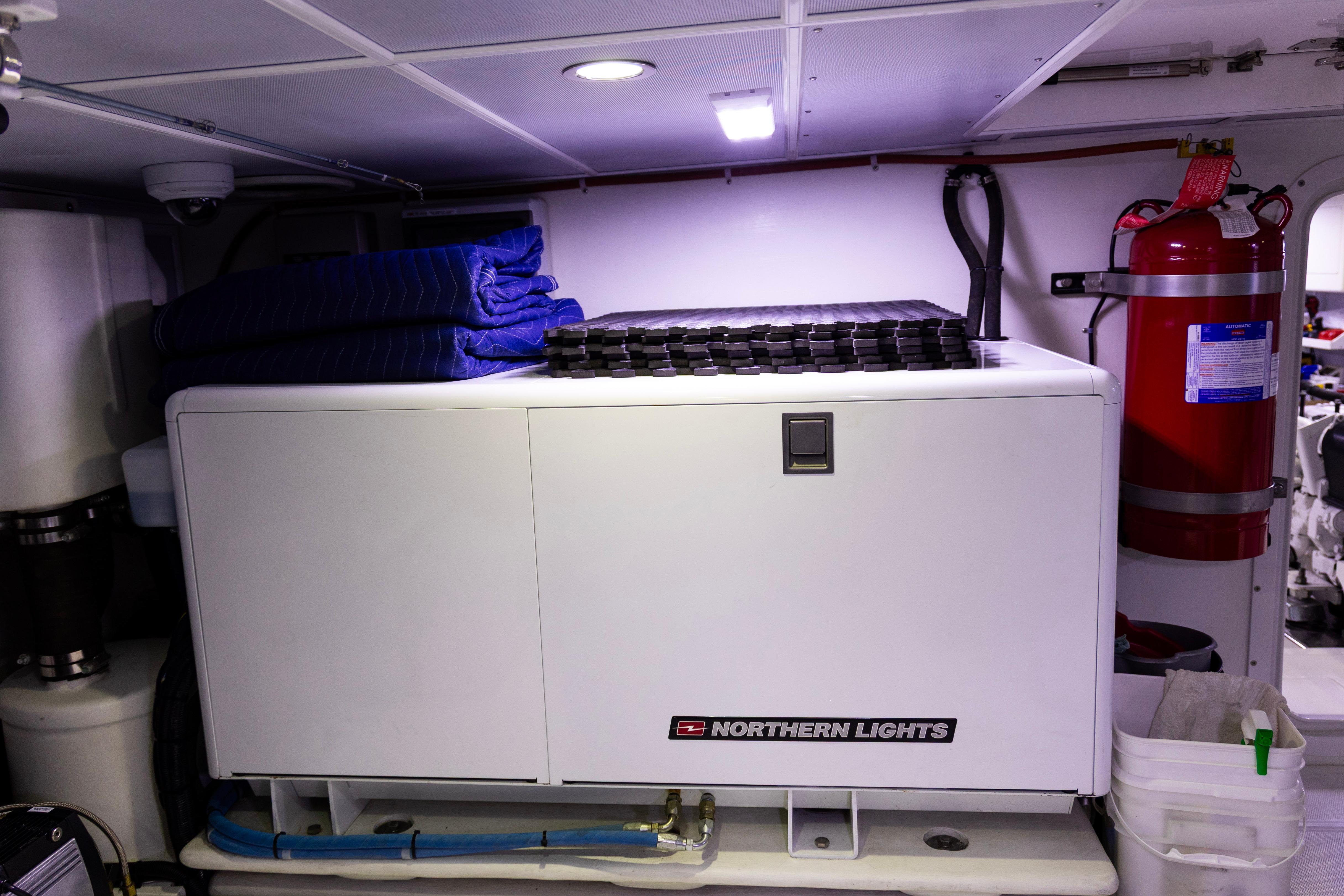 Engine room of 2018 Nordhavn 76 yacht with Northern Lights generator and fire extinguisher.
