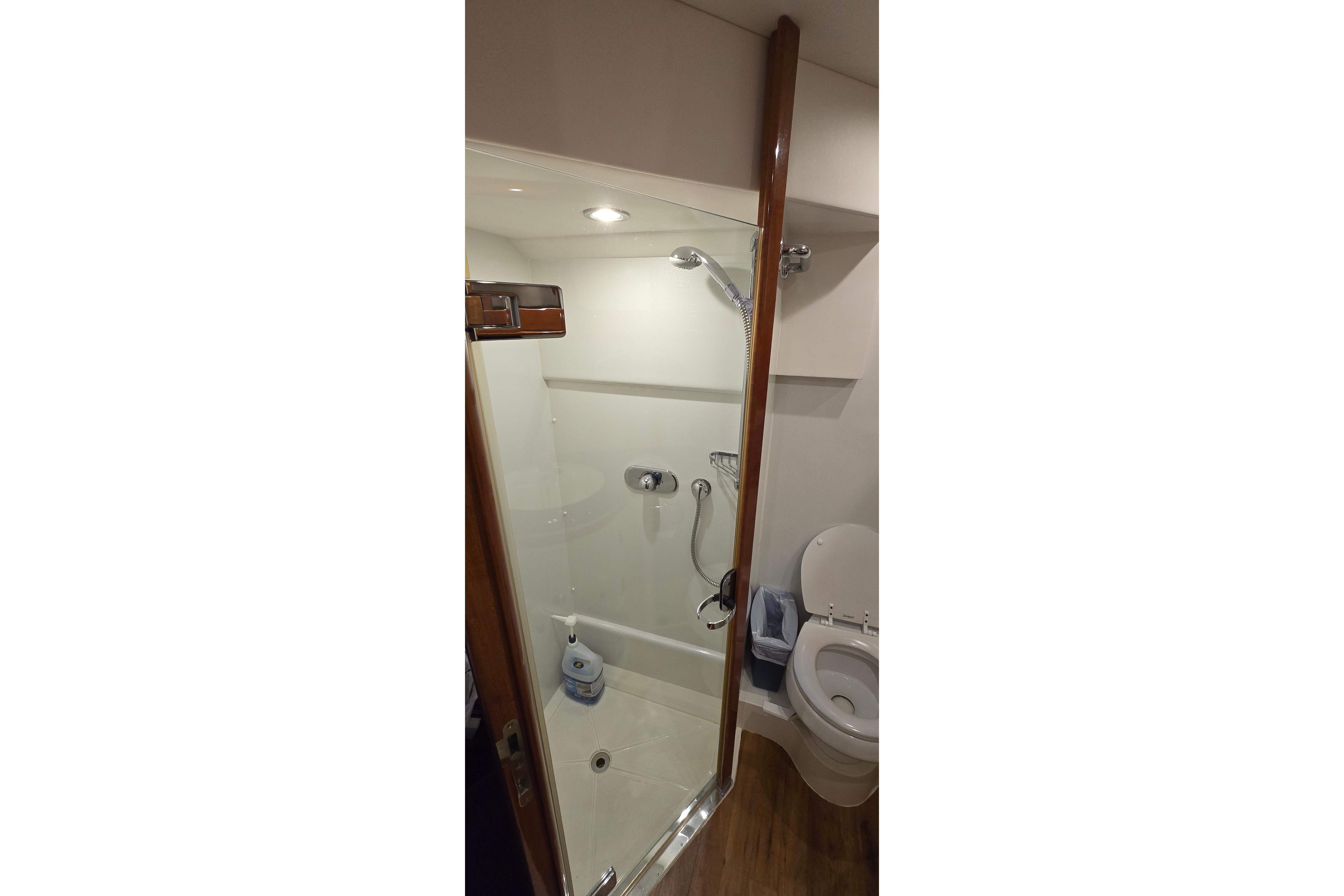 Bathroom interior of 2004 Sunseeker Camargue 50 yacht, featuring shower and toilet.