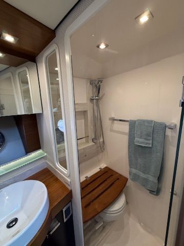 The bathroom of a 2017 Tiara Yachts C44 Coupe with shower and sink.