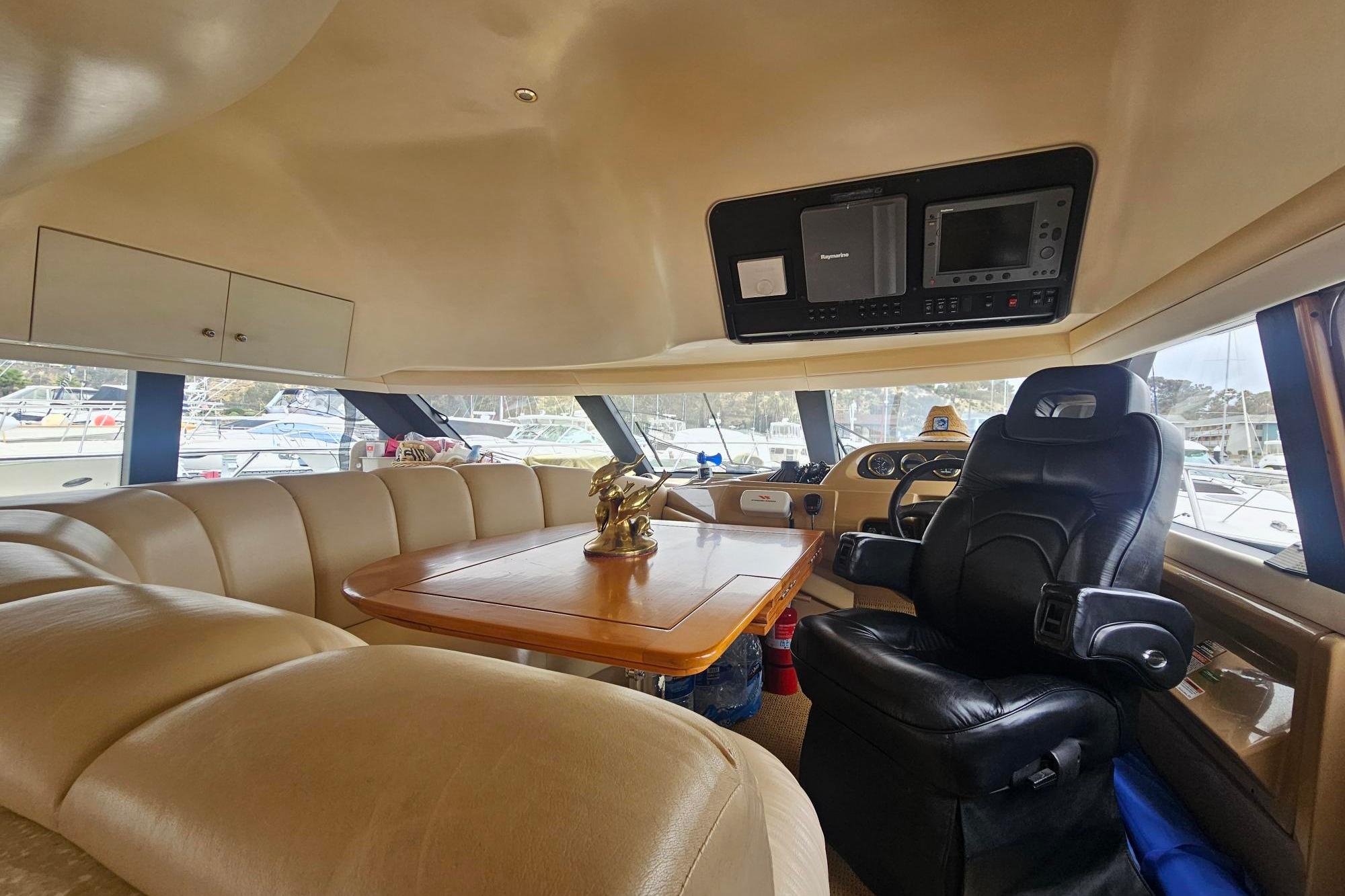 Luxurious interior of a 2002 Carver 450 Voyager Pilothouse with plush seating and navigation equipment.