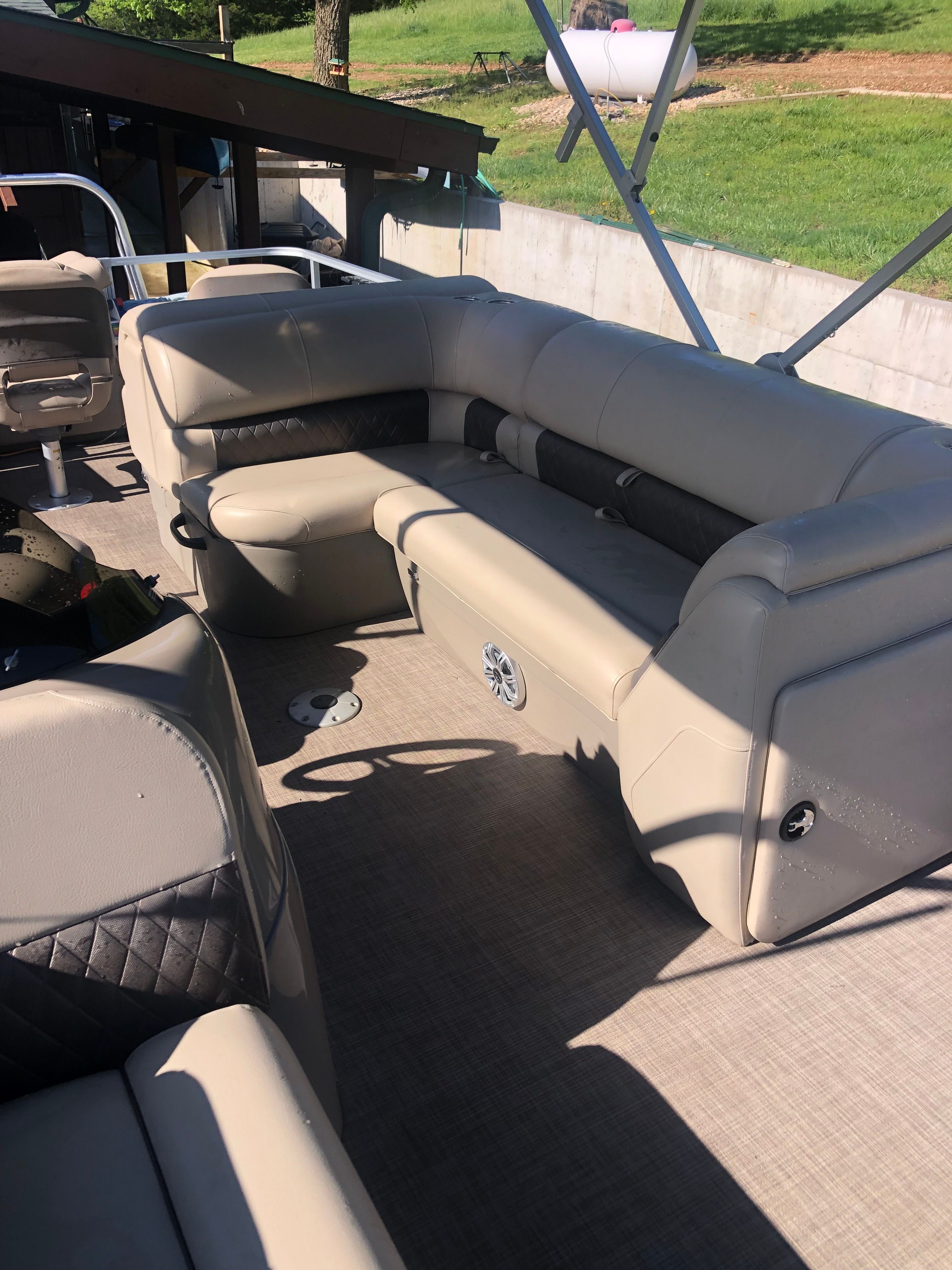 Interior view of a Sun Tracker Fishin' Barge 22 DLX with beige seating and carpeted floor.