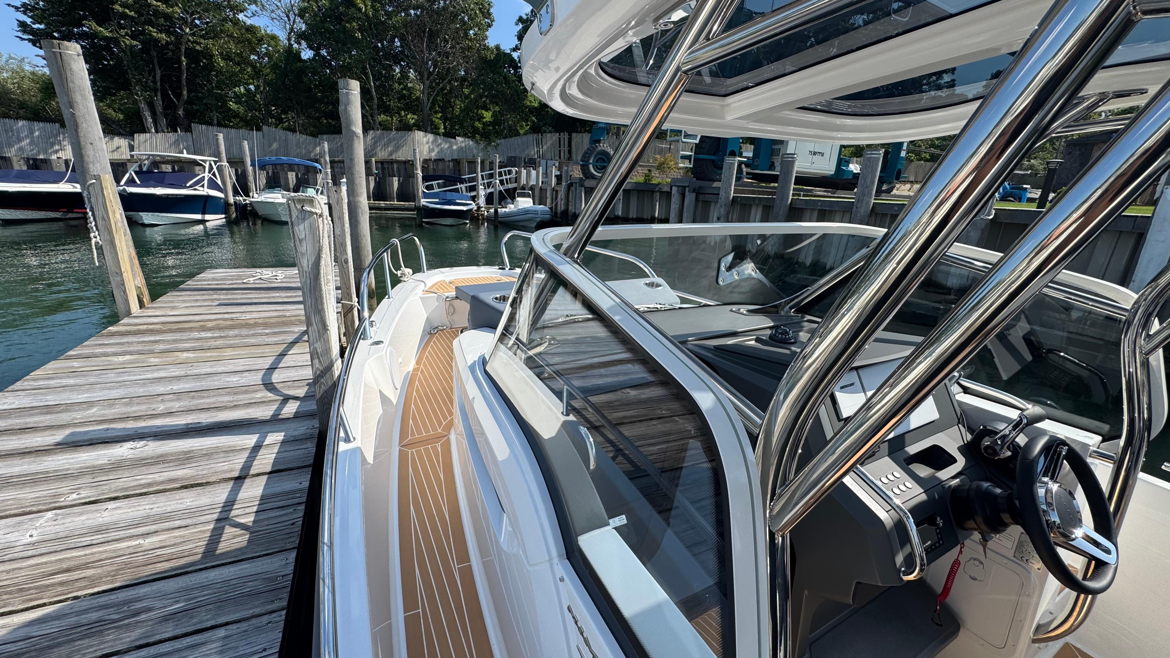 2024 Nimbus T8 boat docked at a marina with sleek design and modern features.