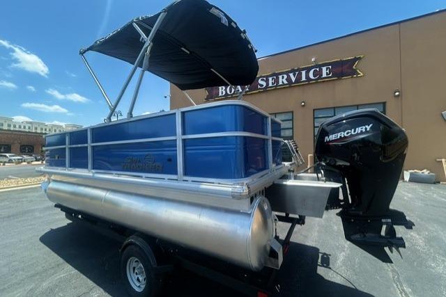 2026 Sun Tracker Party Barge 18 DLX pontoon boat at a boat service center.