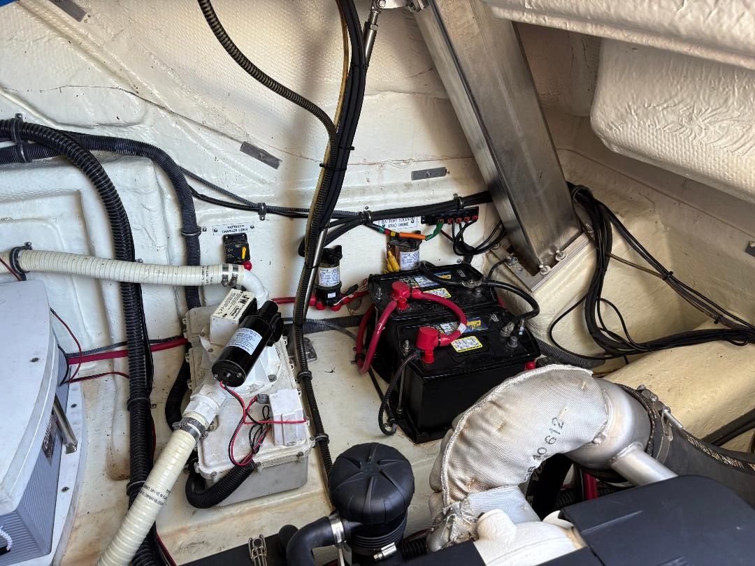 The engine room of a 2011 Formula 45 with batteries, cables, and hoses.