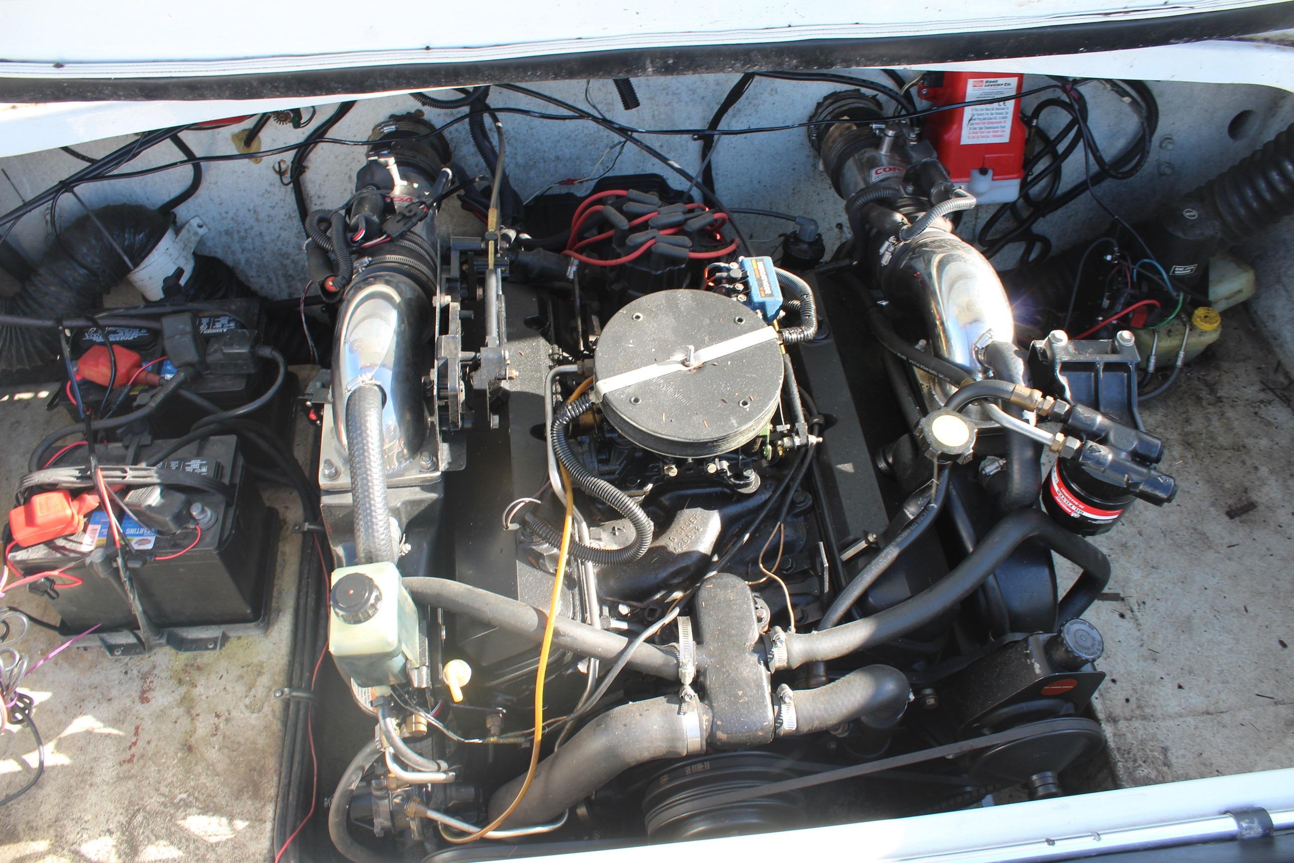 Engine compartment of a 1996 Baja 232 boat, showcasing mechanical components and wiring.