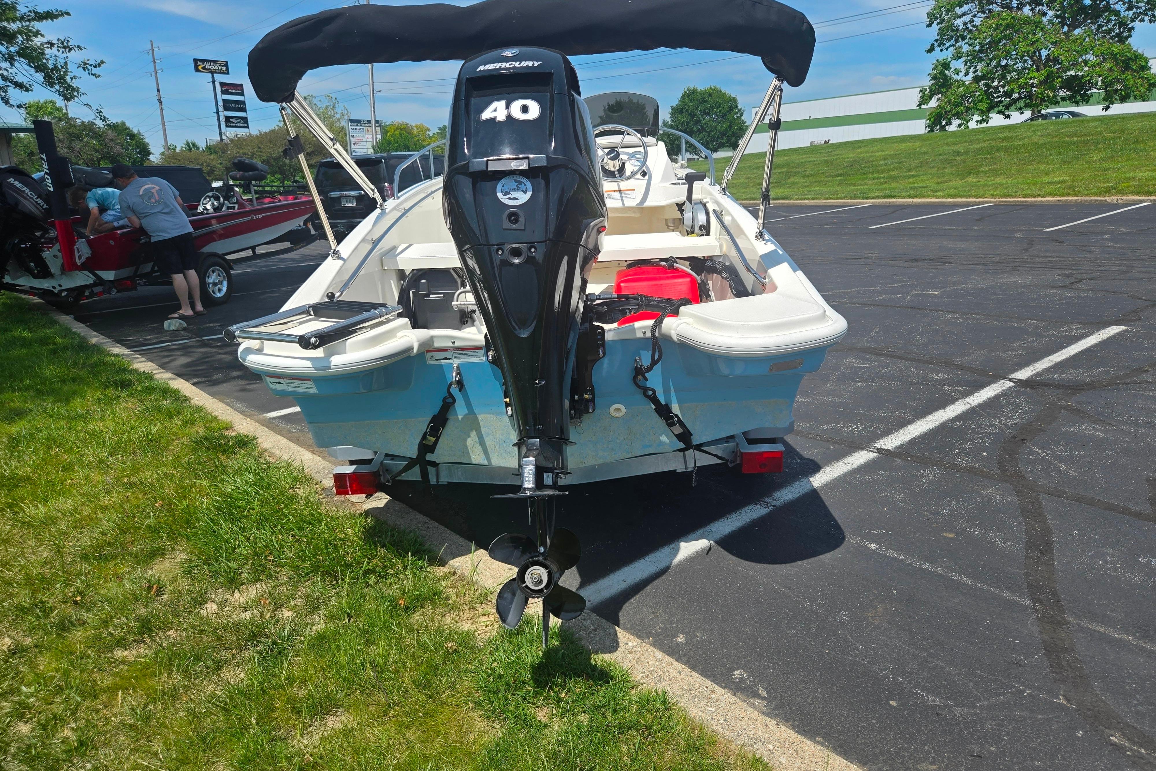 2025 Boston Whaler 130 Super Sport with Mercury 40 engine in parking lot.
