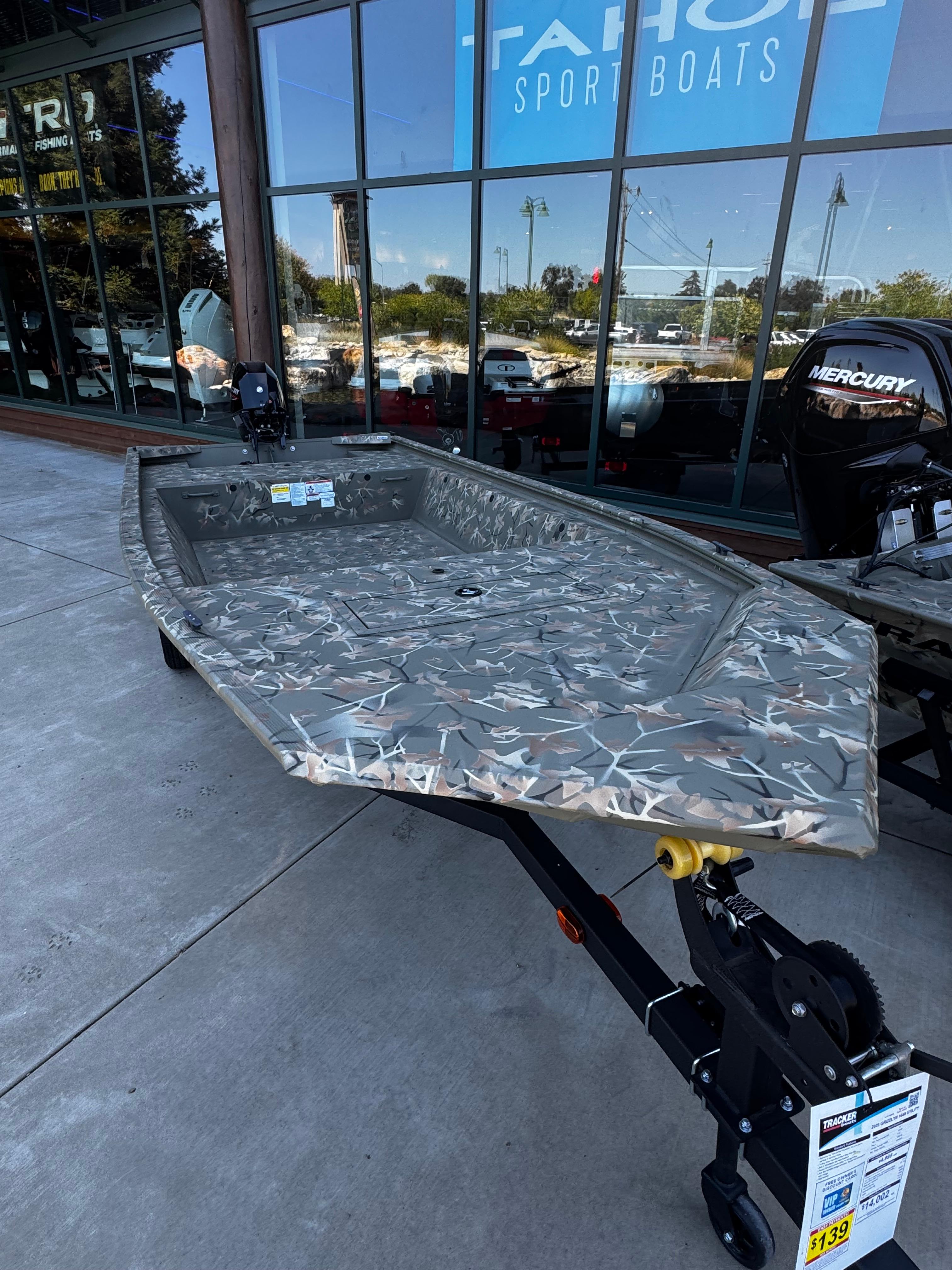 2025 Tracker Grizzly 1648 Jon boat displayed outside Tahoe Sport Boats showroom.